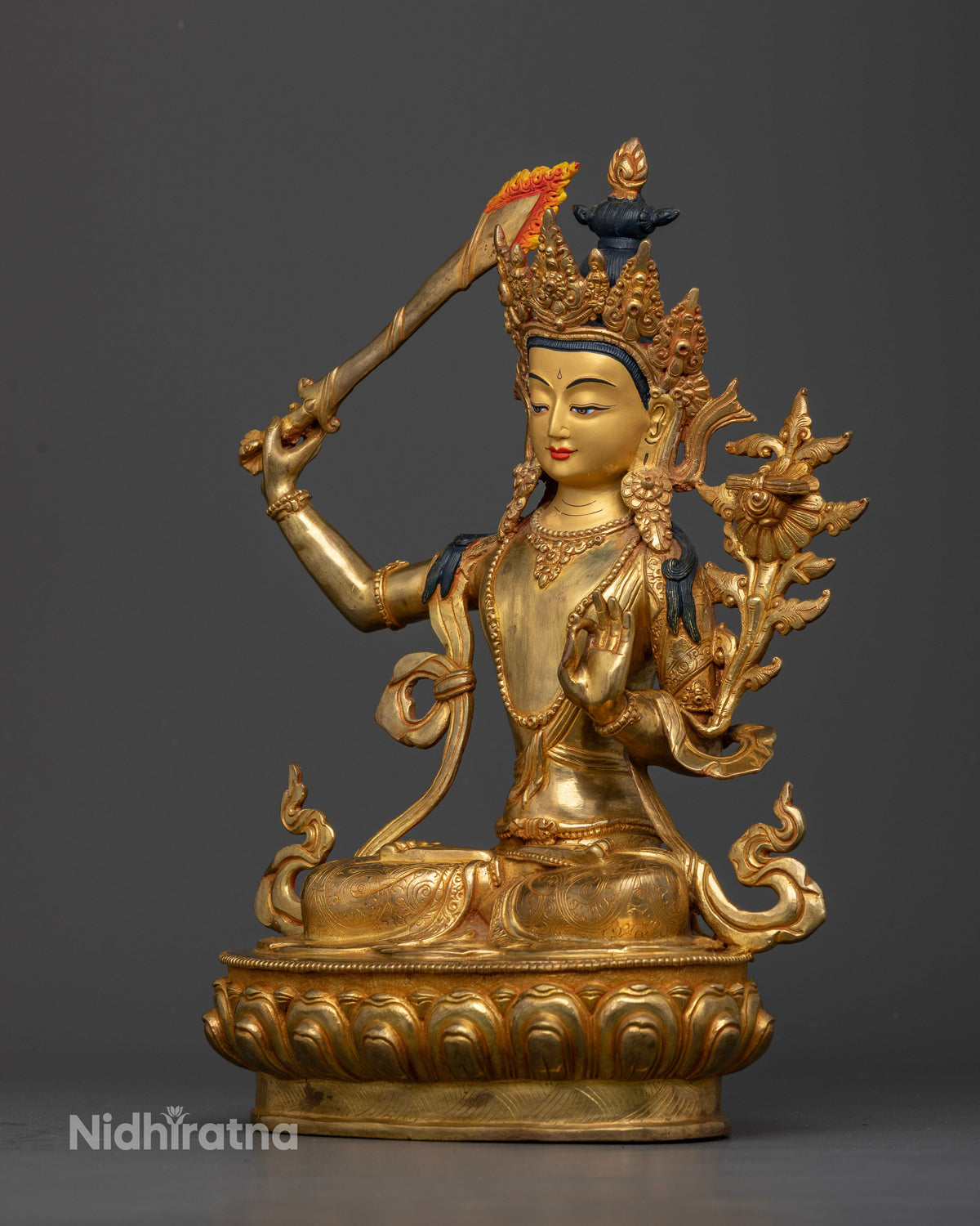 Manjushri Statue on hand carved lotus pedestal with intricate gold gilded details.