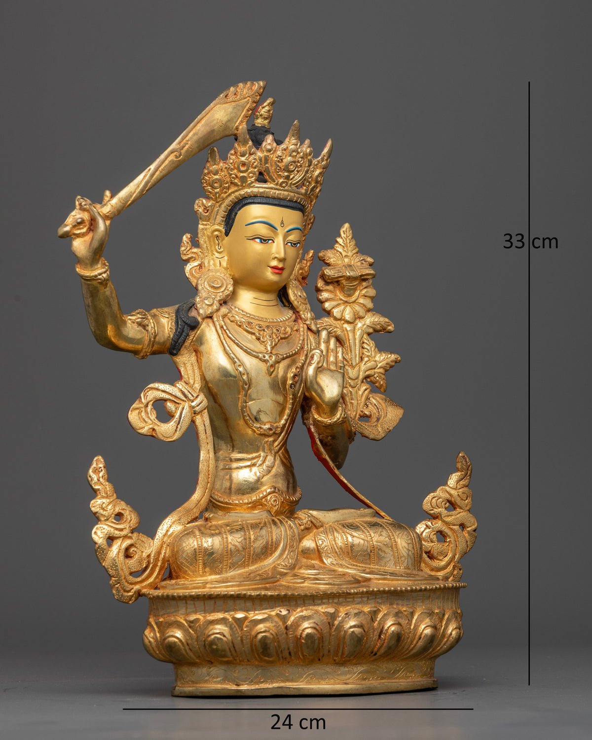 Manjushri Statue seated on lotus pedestal with Prajnaparamita scripture.