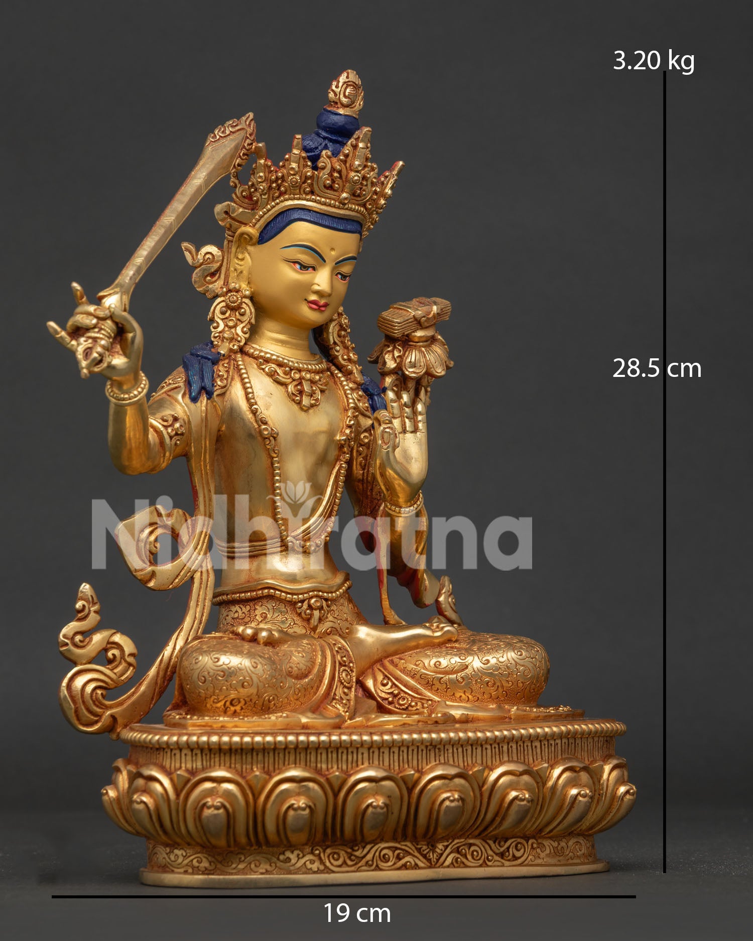 Manjushri statue side view holding flaming sword and utpala flower with sacred sutra.