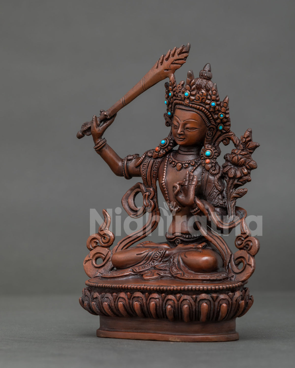 Manjushri statue with prajnaparamita sutra and semi precious stone adornments.