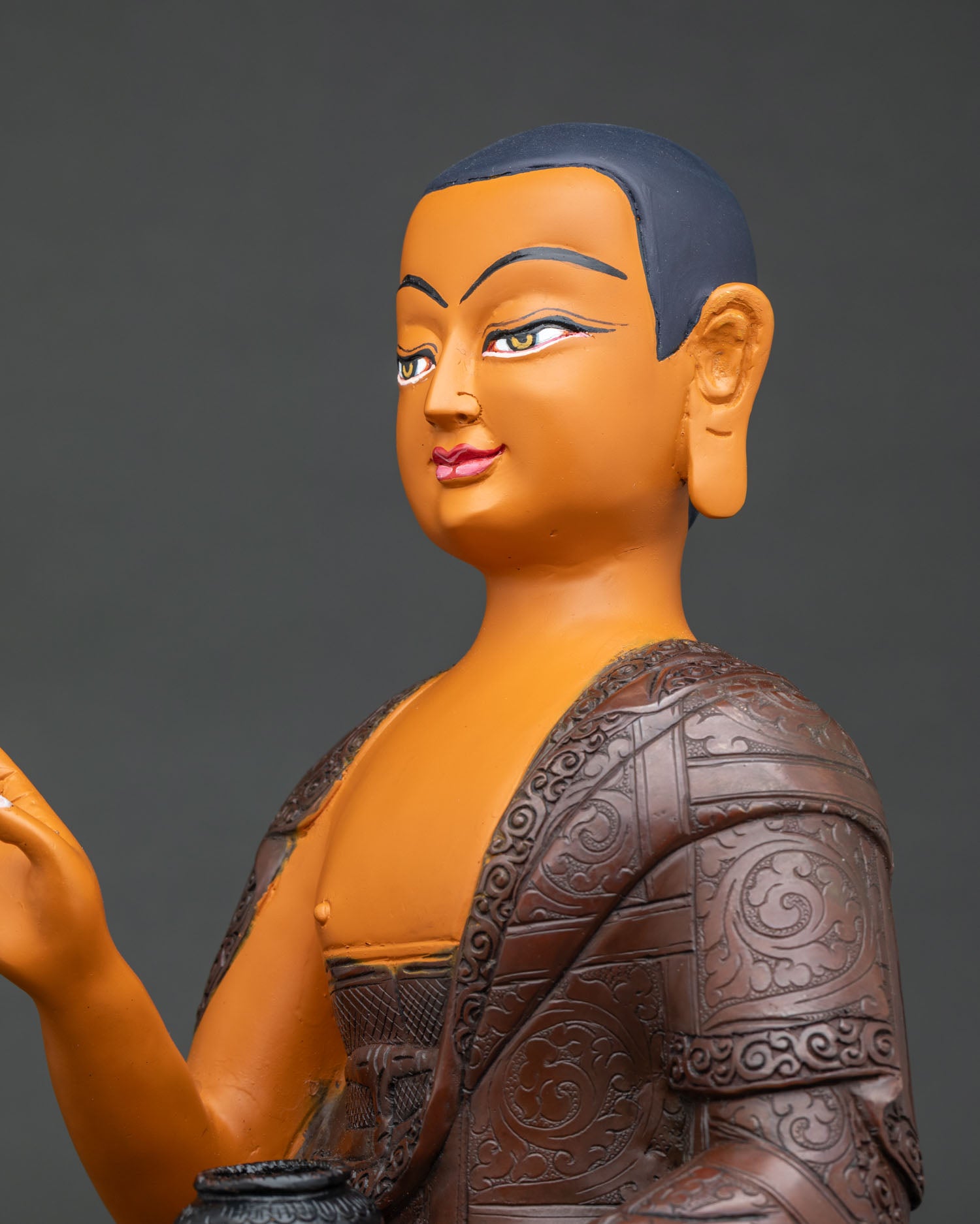 Maudgalyayana statue side close up, oxidized copper robe detailing