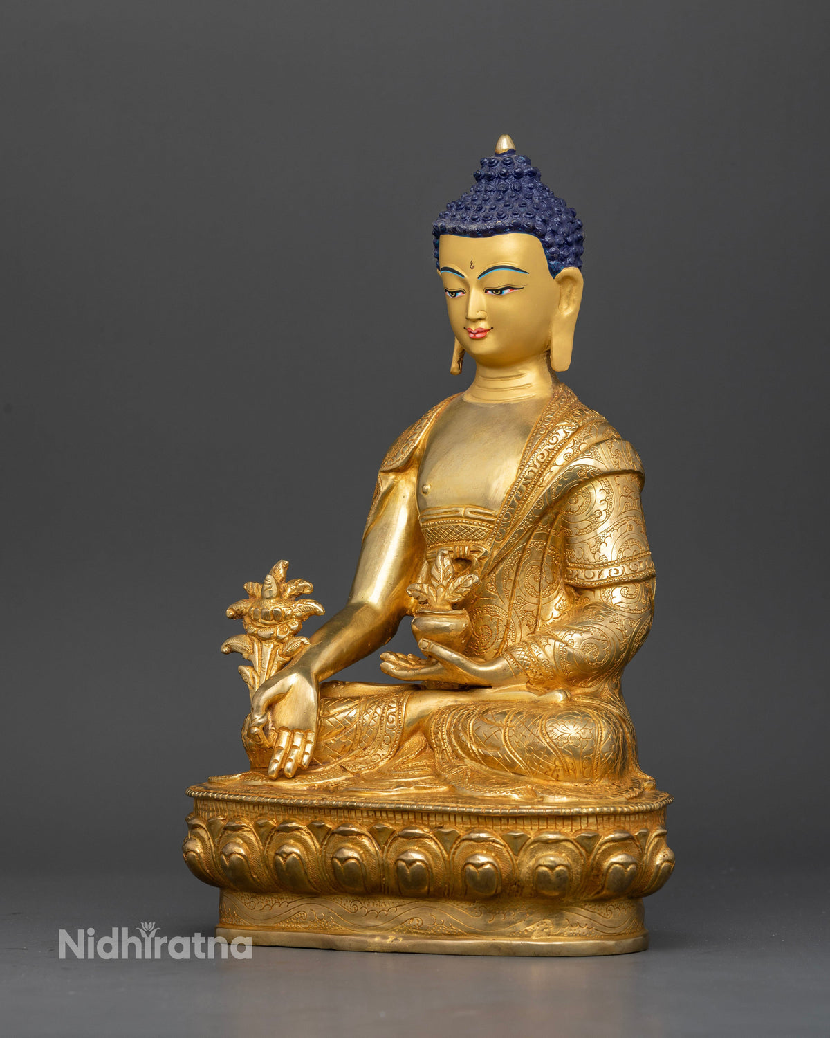 Medicine buddha bhaisajyaguru seated in meditation on hand carved lotus pedestal.