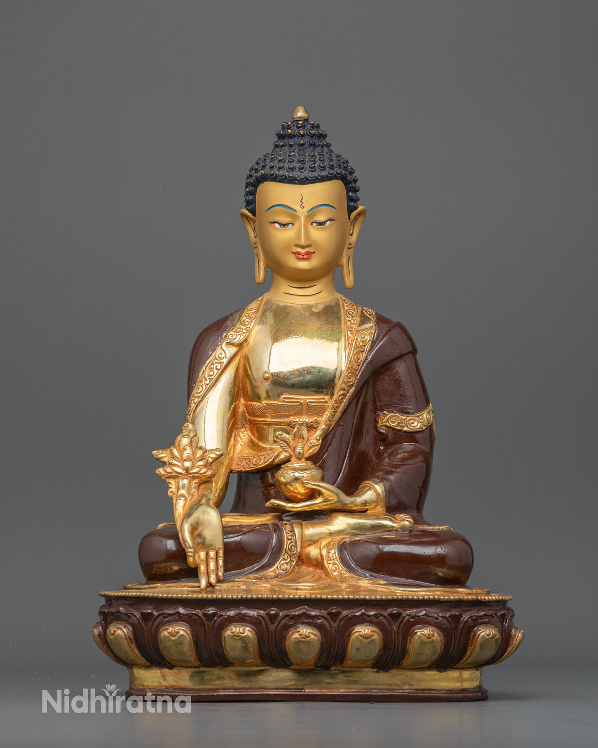 Medicine Buddha statue holding a bowl of healing nectar and the sacred myrobalan plant.