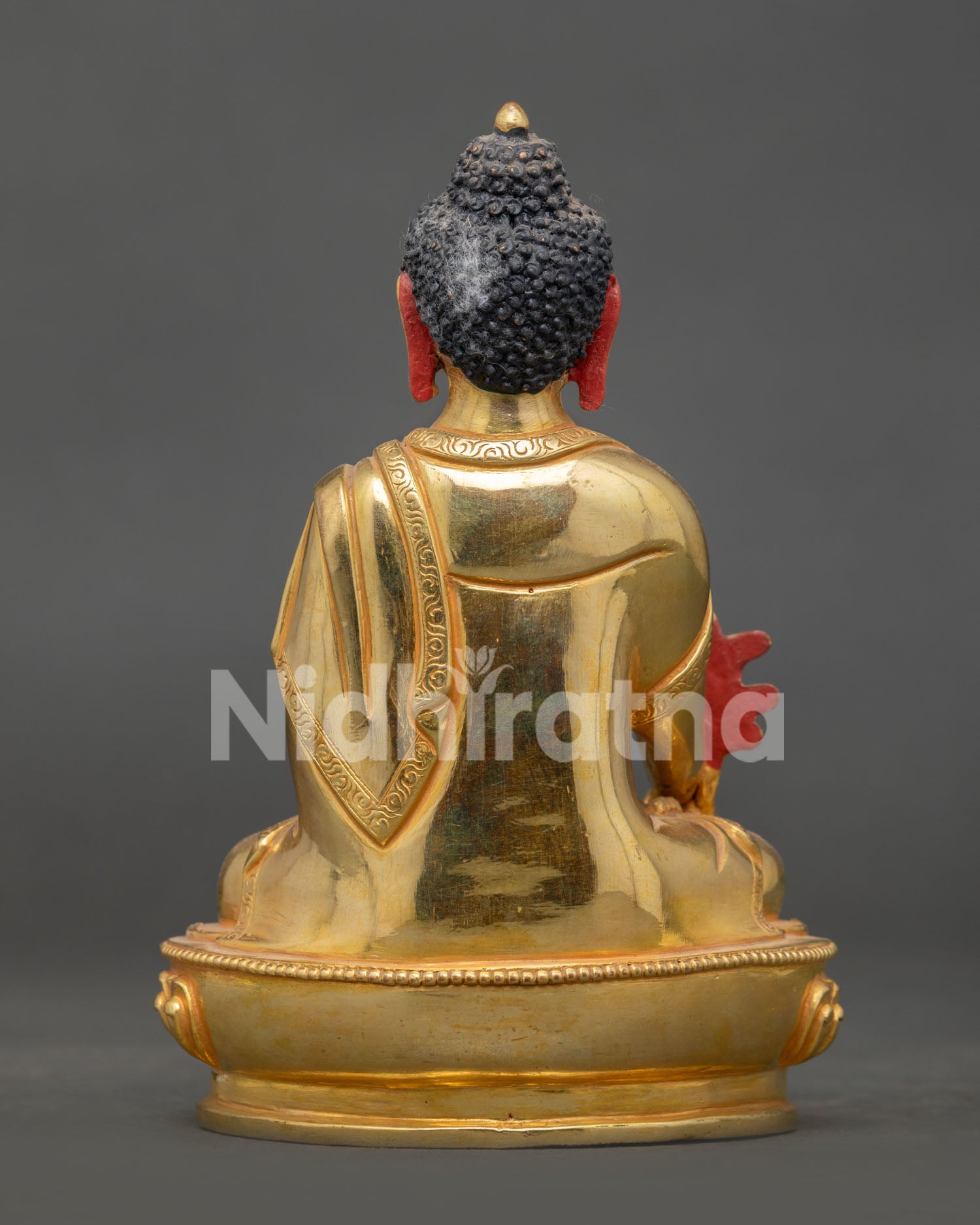 Medicine buddha statue showing intricate copper craftsmanship and buddhist artwork.