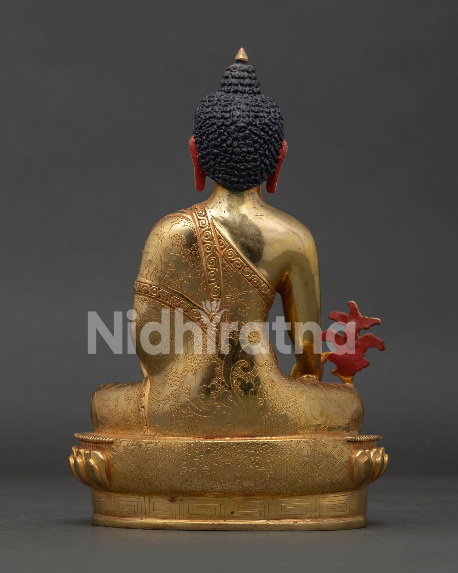 Medicine Buddha statue with carved vajra lotus pedestal and gilded finish.