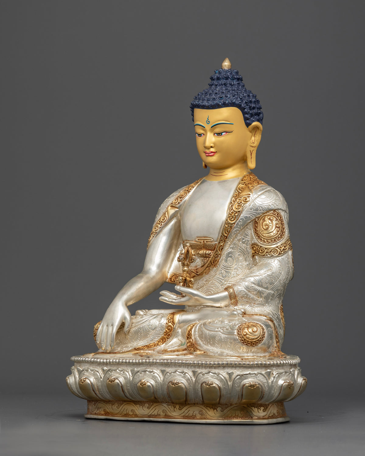 Mitrugpa Buddha copper statue with gold-gilded monk robes, silver-plated accents, and hand-carved floral motifs