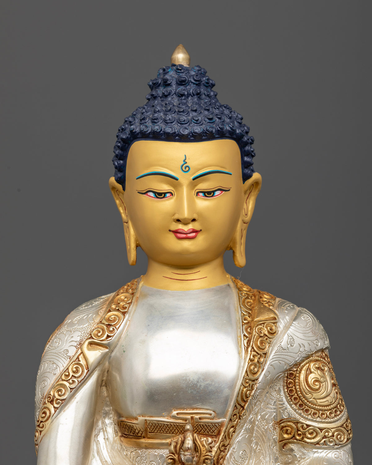 Mitrugpa Buddha gold-painted face with intricate details and traditional Newari metalwork from Patan