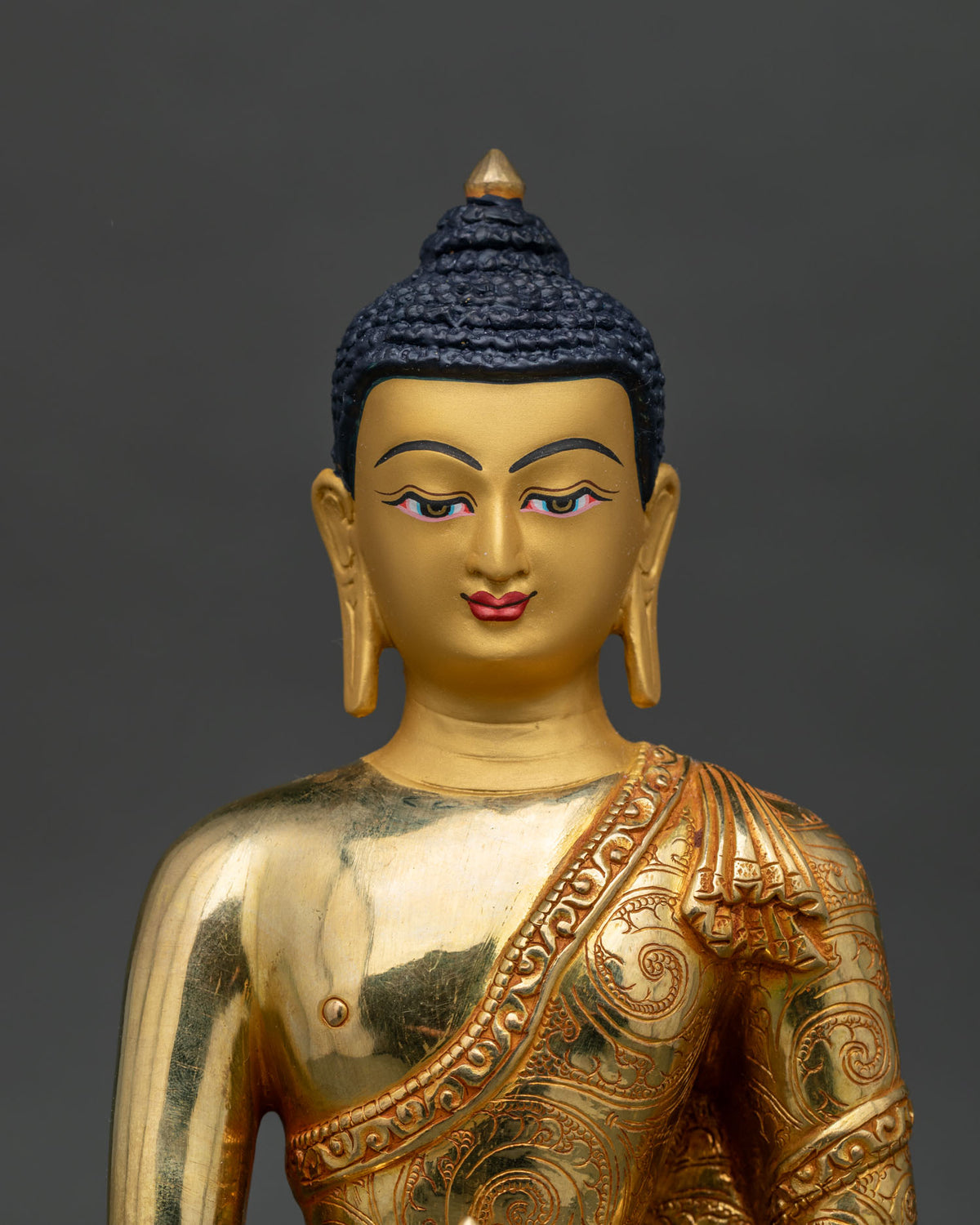 Mitrugpa statue 24K gold face earth touching mudra vajra close up.