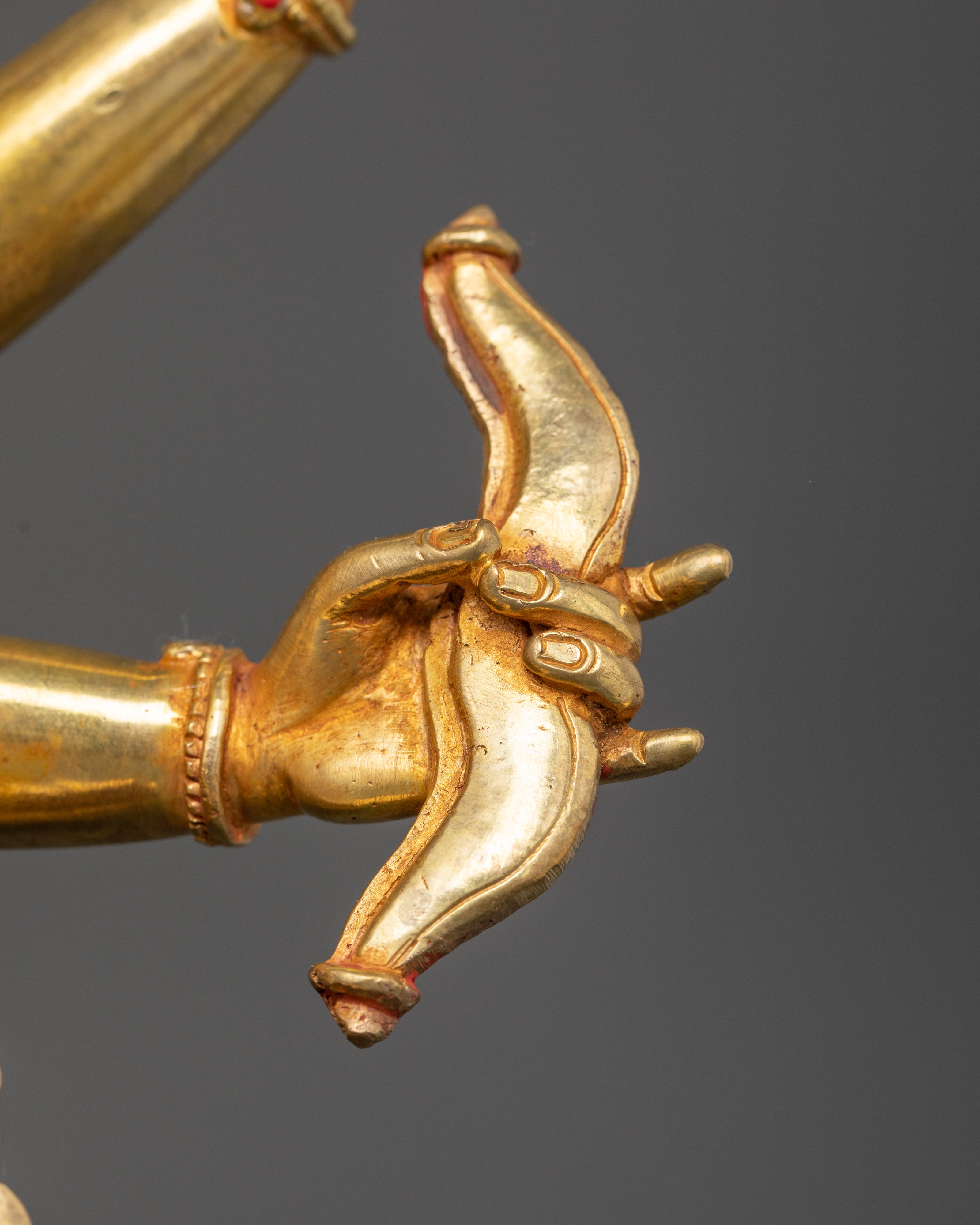 bow held by one of the hand of gold plated namgyalma statue