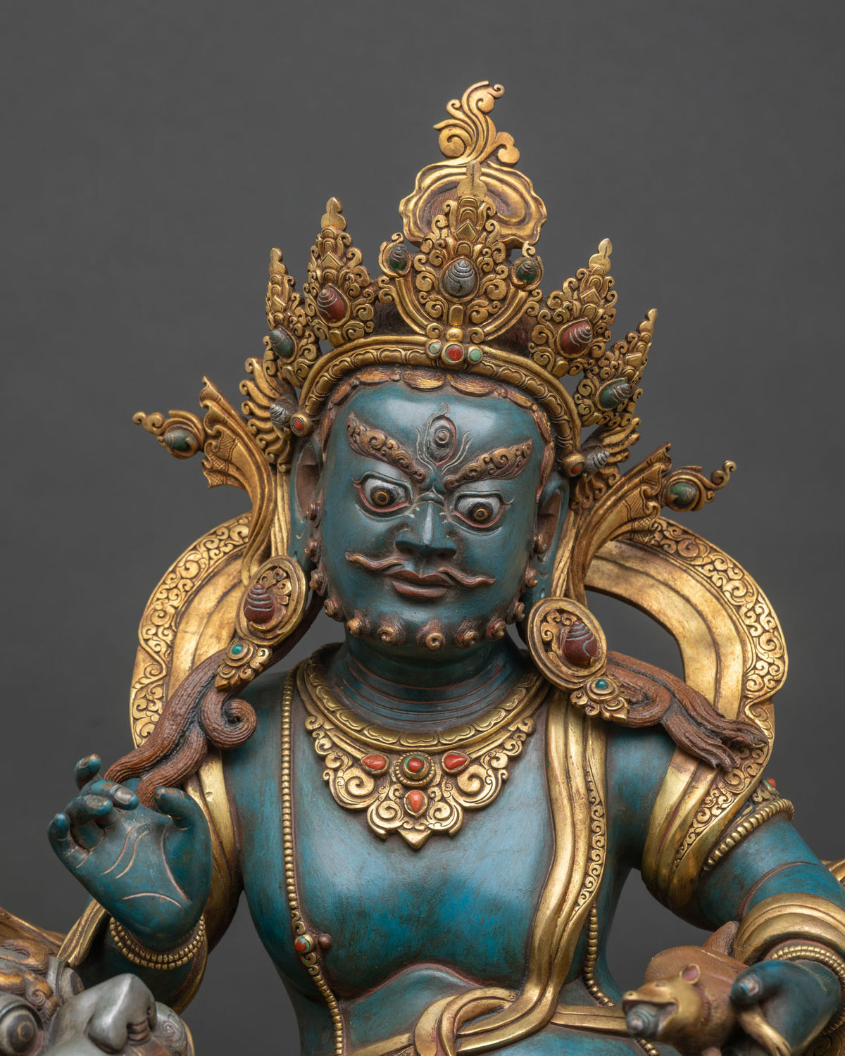 Namtoshe Statue close up showing gold-gilded ornaments and crown on blue copper body