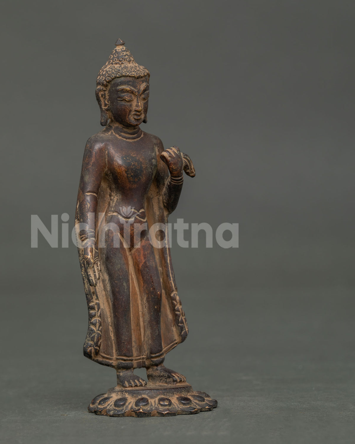 Nepalese Dipankara Buddha statue in copper with antique finish and serene expression.
