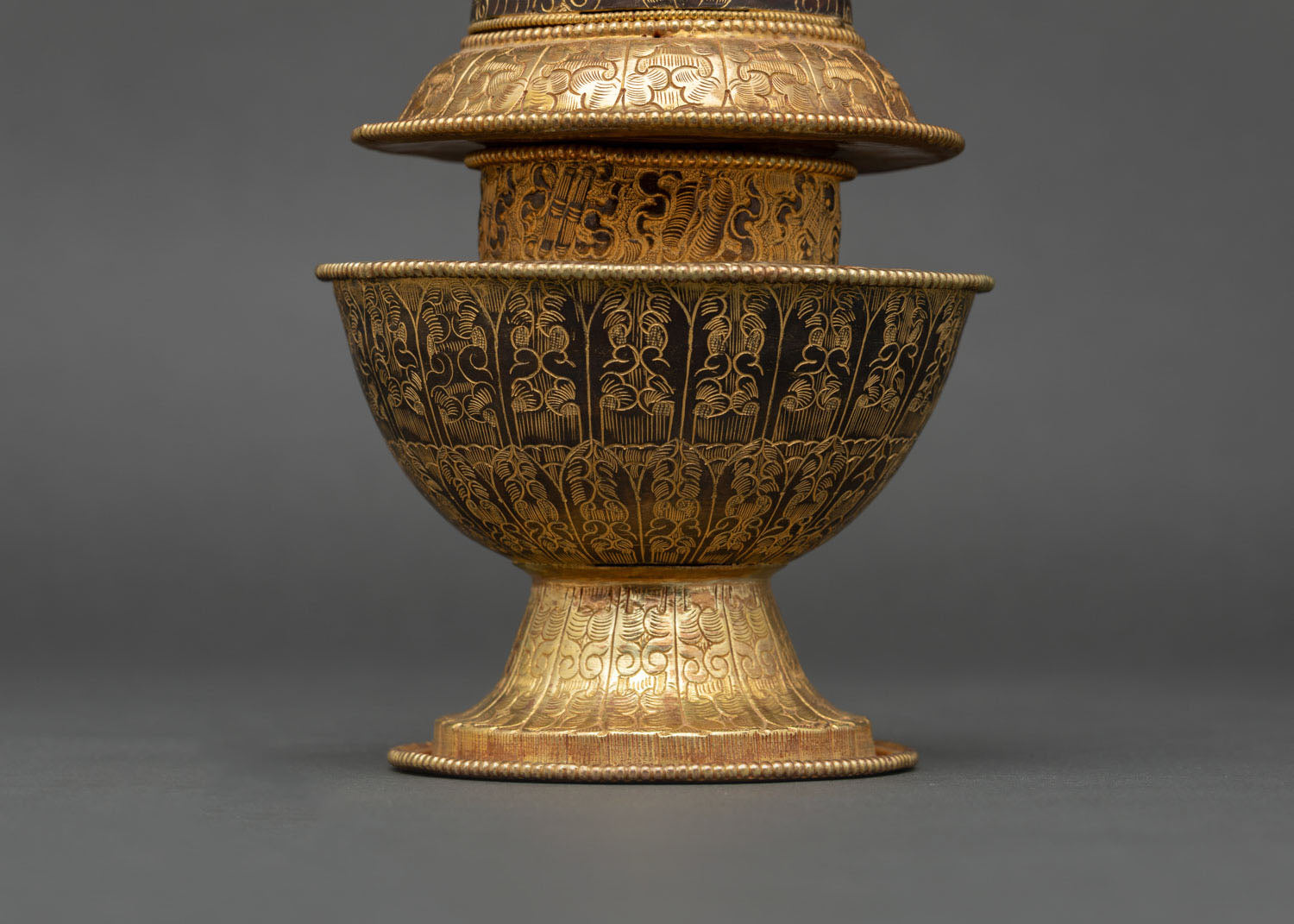 nepalese neshi rice pot with hand-carved cloud motifs and gold detailing