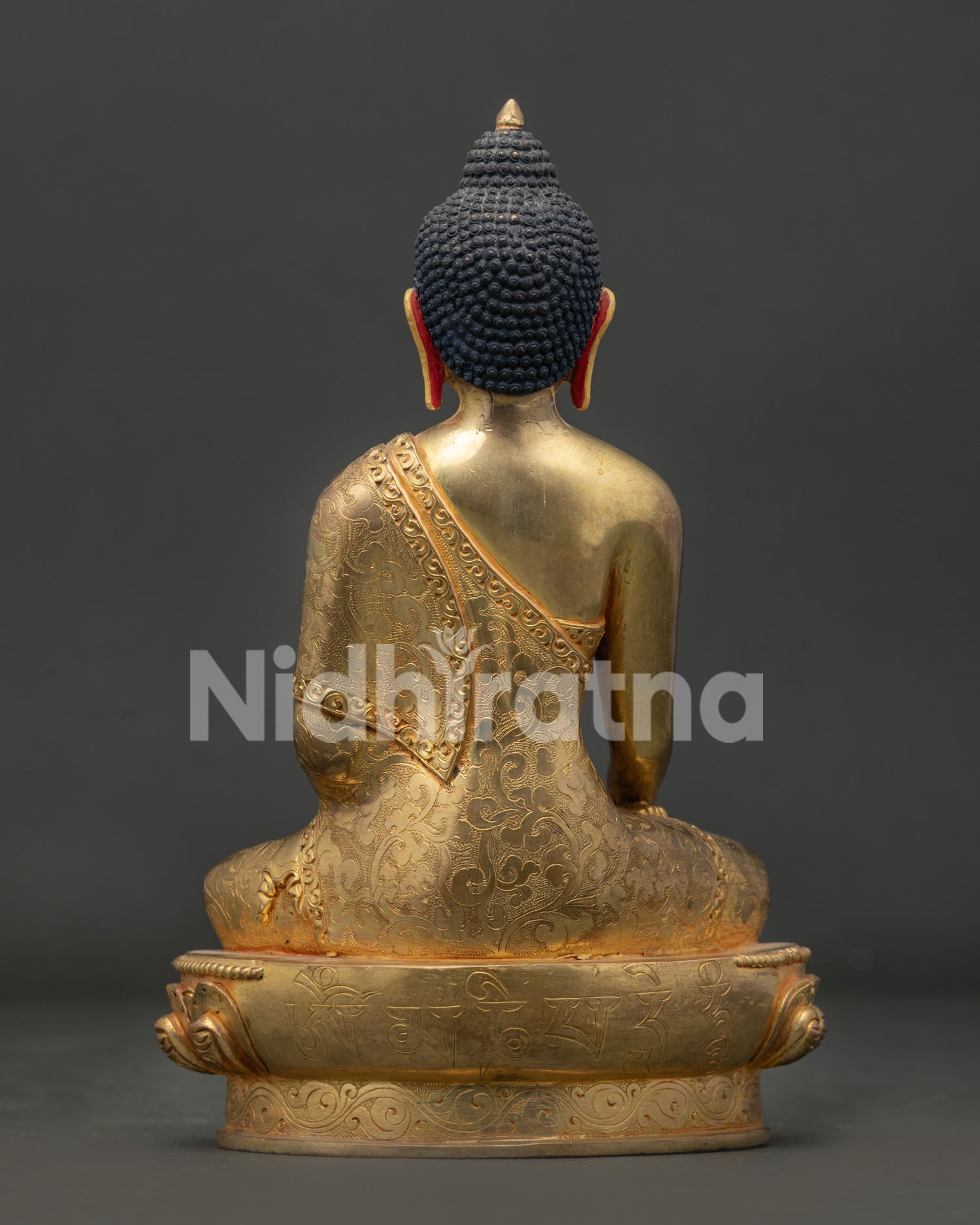 Nepalese shakyamuni buddha statue seated on lotus pedestal for meditation.