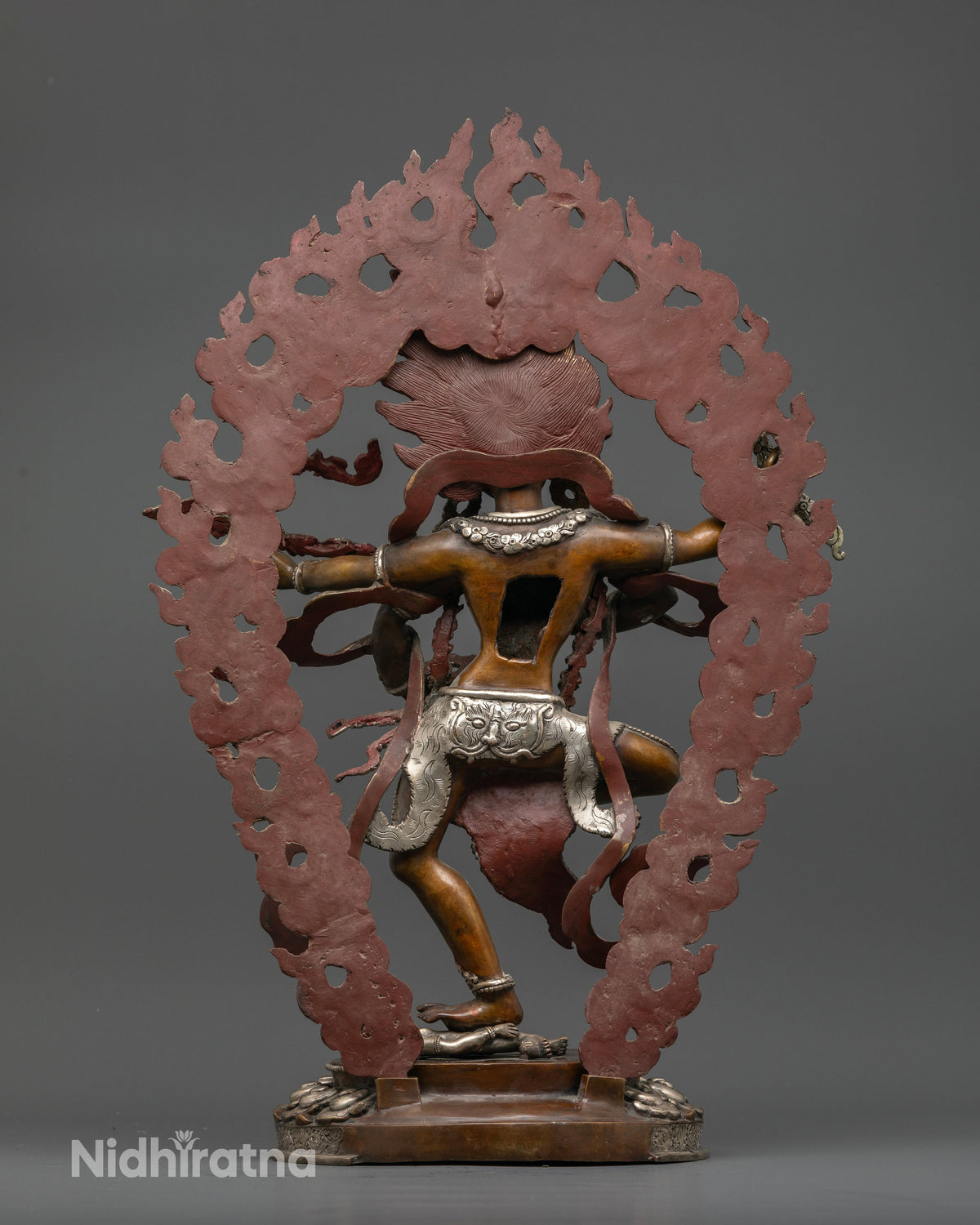 Newari handcrafted Kurukulla statue showcasing intricate carvings and a large silver plated halo.