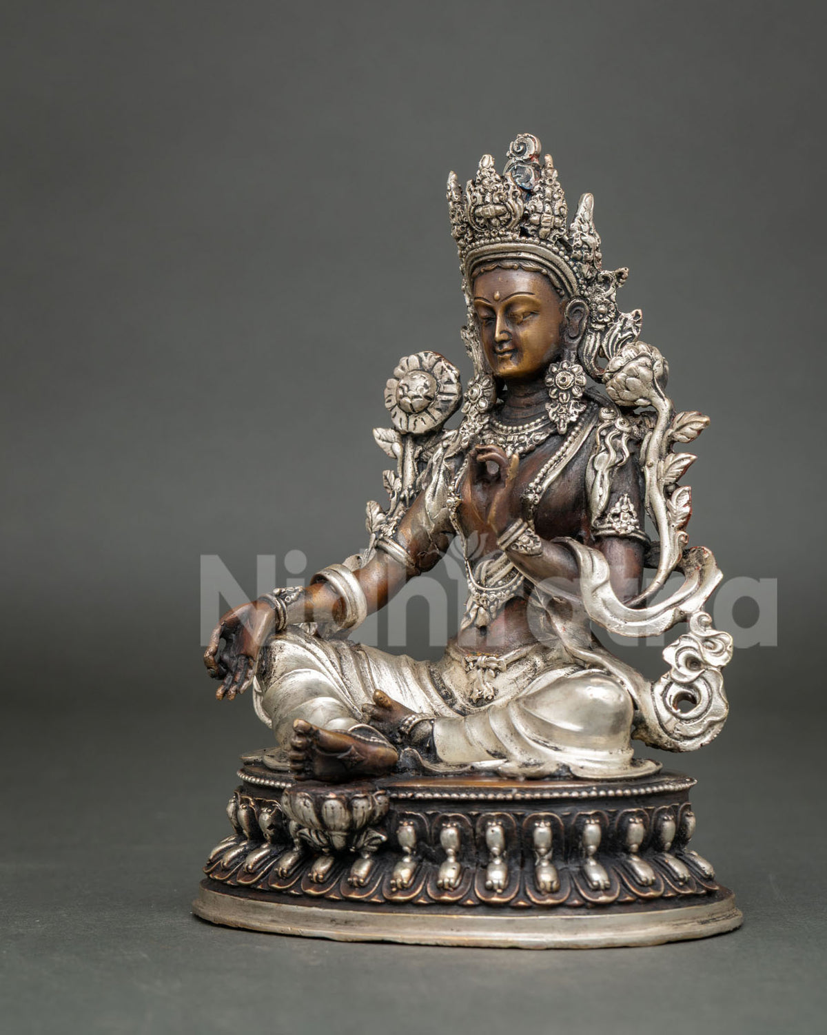 Opposite three-quarter view of Green Tara meditation statue with brown patina and silver accents