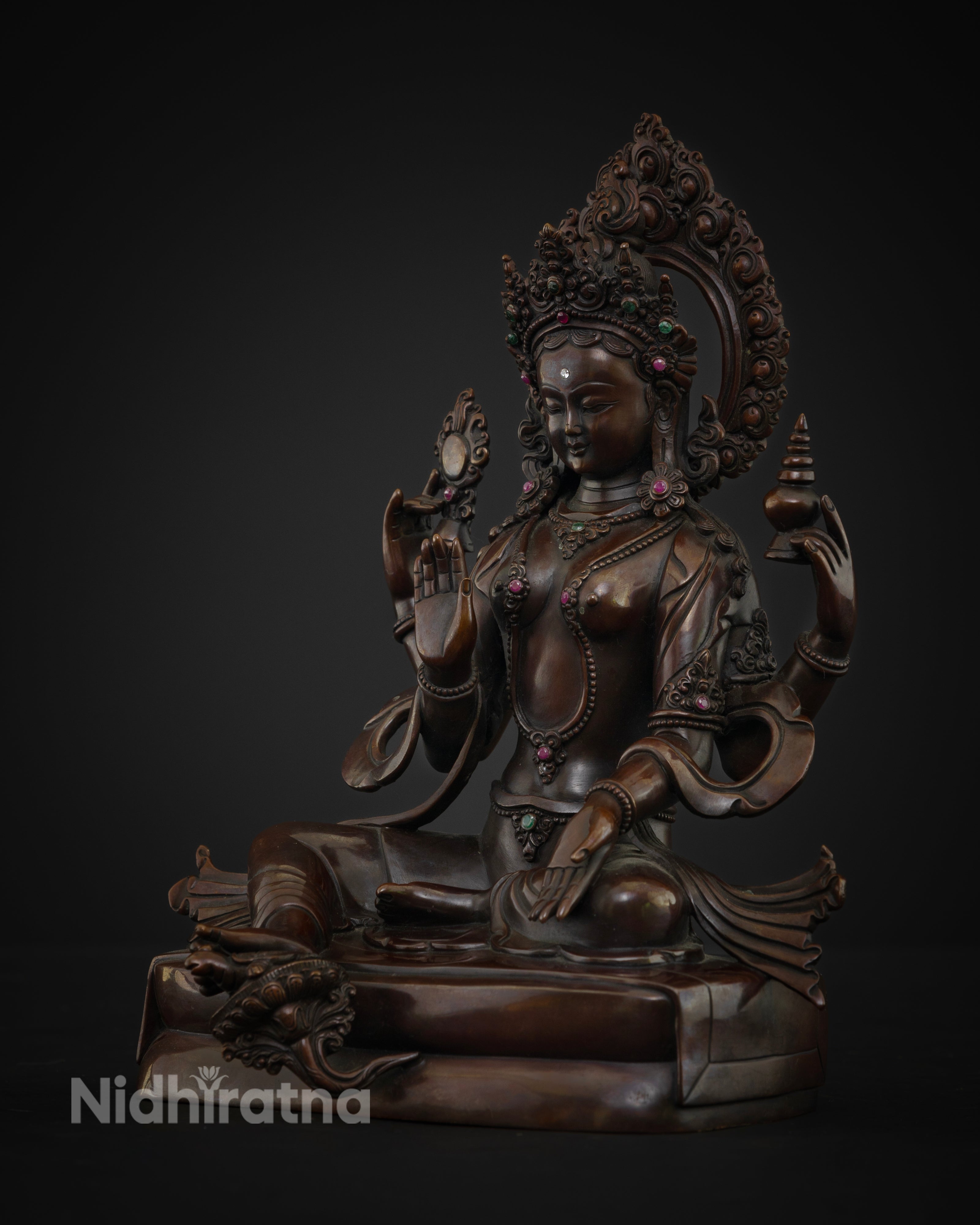 Oxidized copper Lakshmi statue showcasing chased petals semi precious stones and sacred detailing