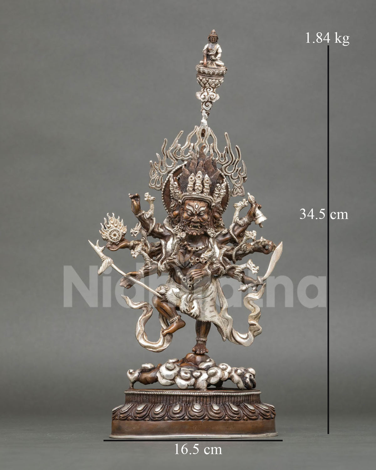 Oxidized copper Ucchusma statue with silver plating, front view of the wrathful deity with flaming halo
