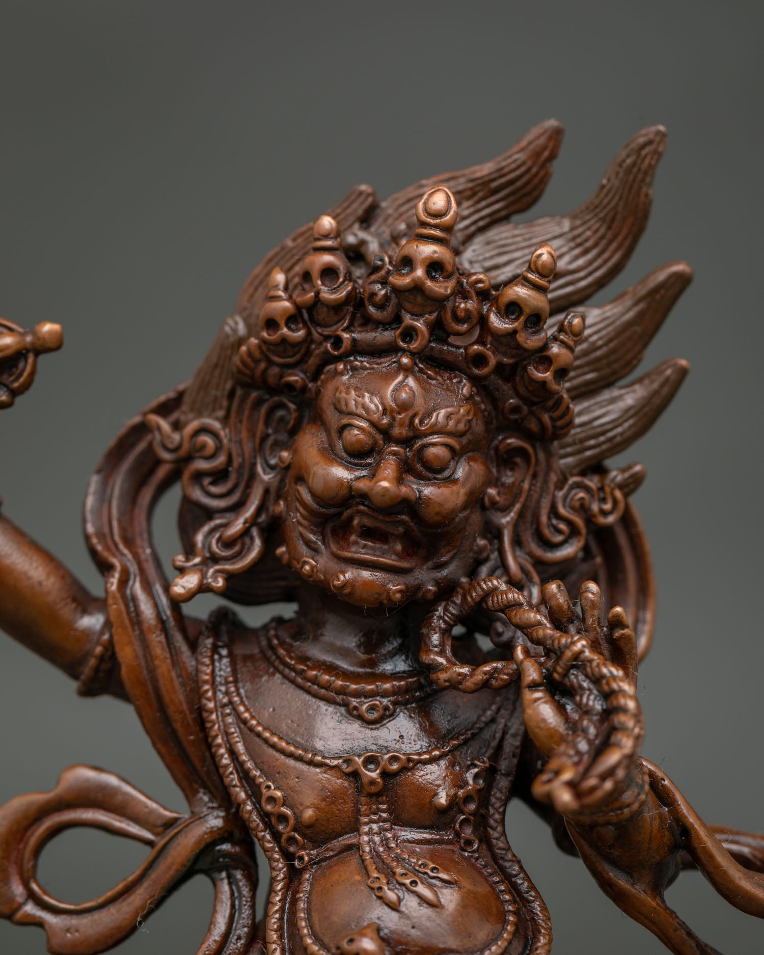 Oxidized Copper Vajrapani Statue with wrathful expression and lotus pedestal.