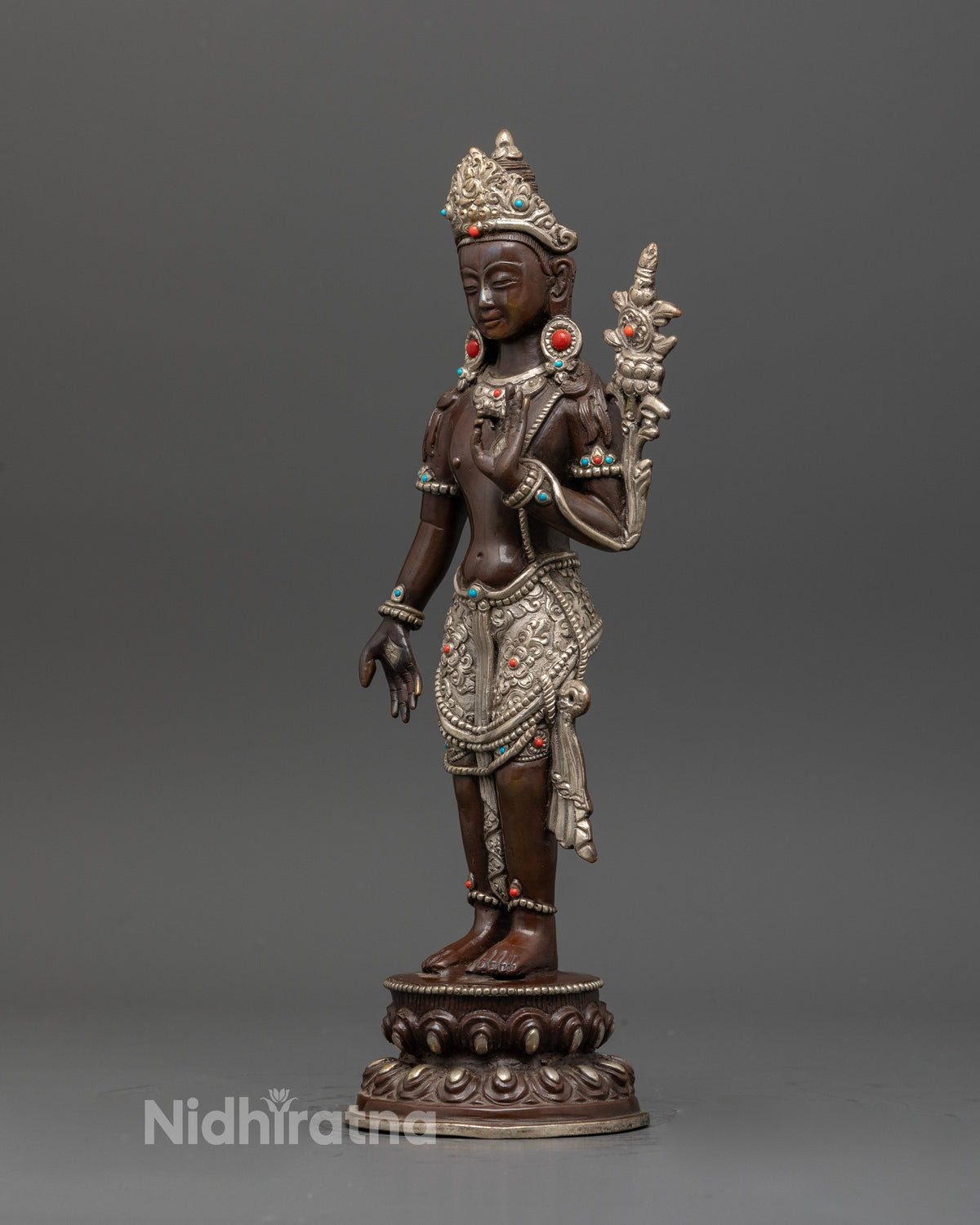 Padmapani statue on double lotus pedestal with oxidized silver finish.