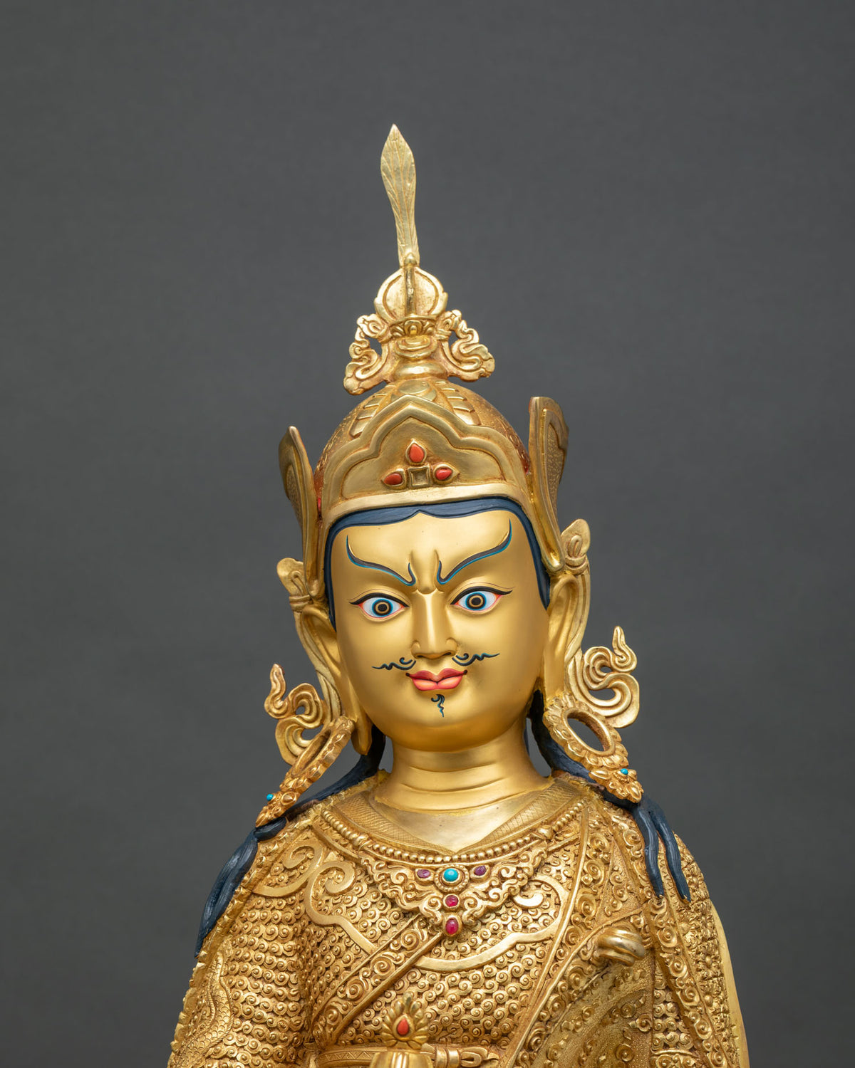 Padmasambhava statue close up, vajra, skull cup and lotus throne in 24K gold fire-gilded copper