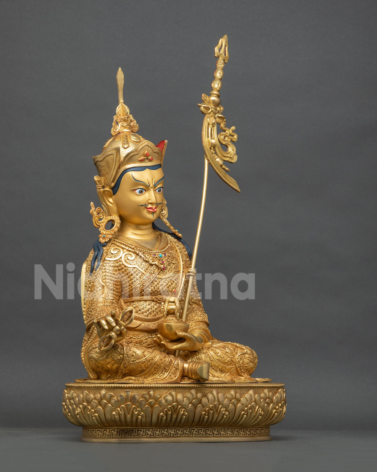 Padmasambhava statue right side view, vajra, skull cup and khatvanga in gold fire-gilded copper