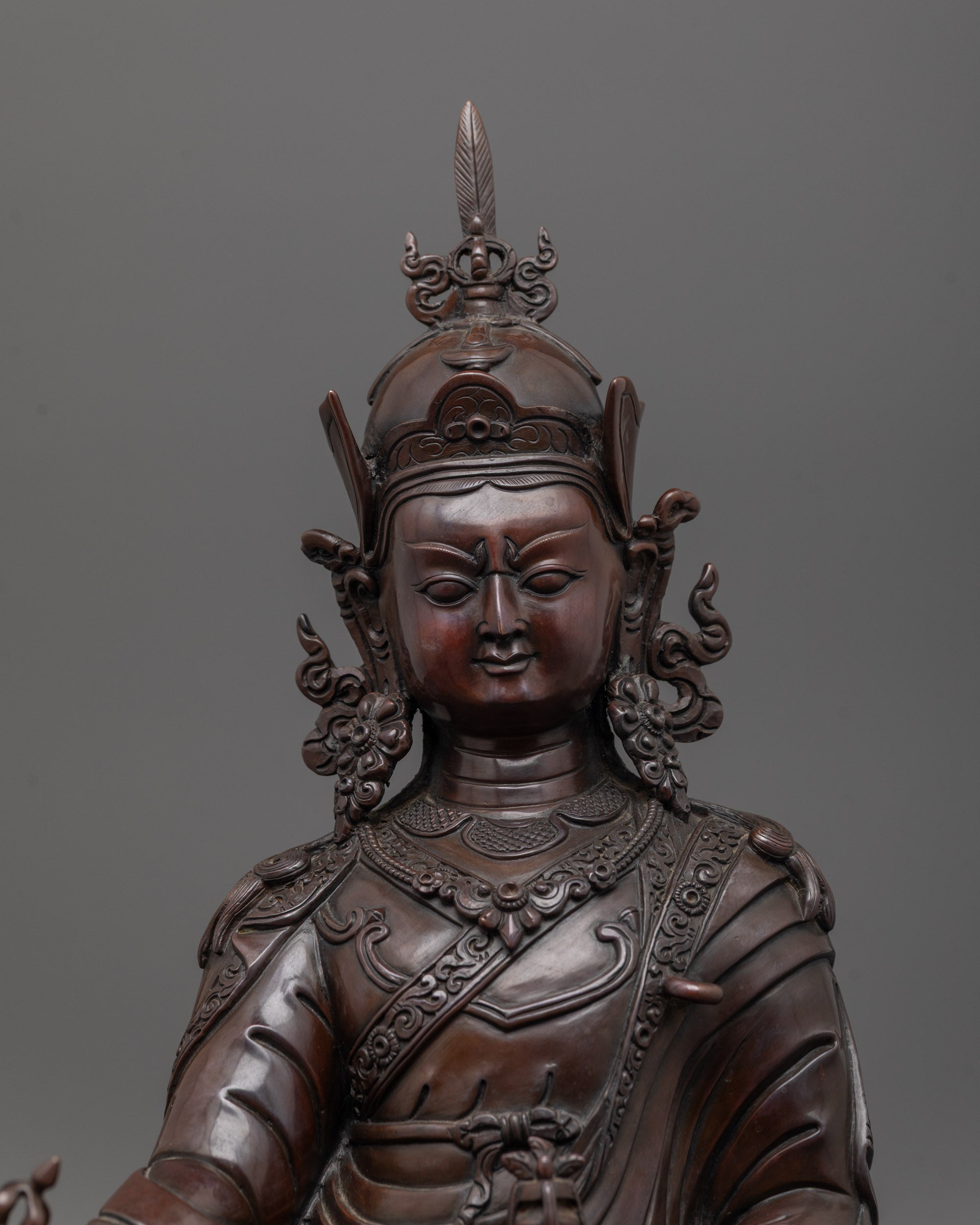 padmasambhava statue close up showing oxidized copper face and detailed artisan carvings
