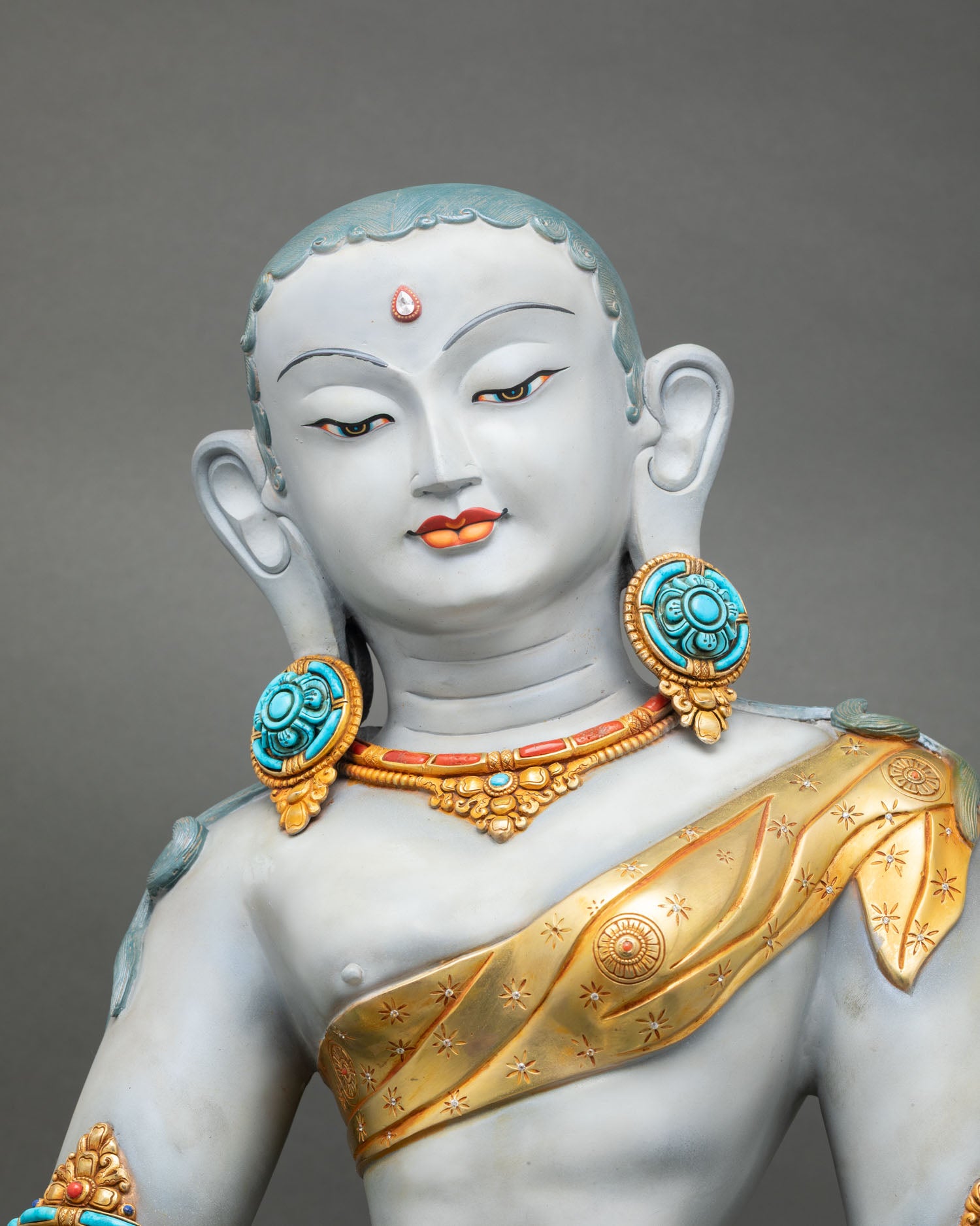 Parvati close up gold painted face detail ornate jewelry floral motifs semi precious stones handmade nepal statue