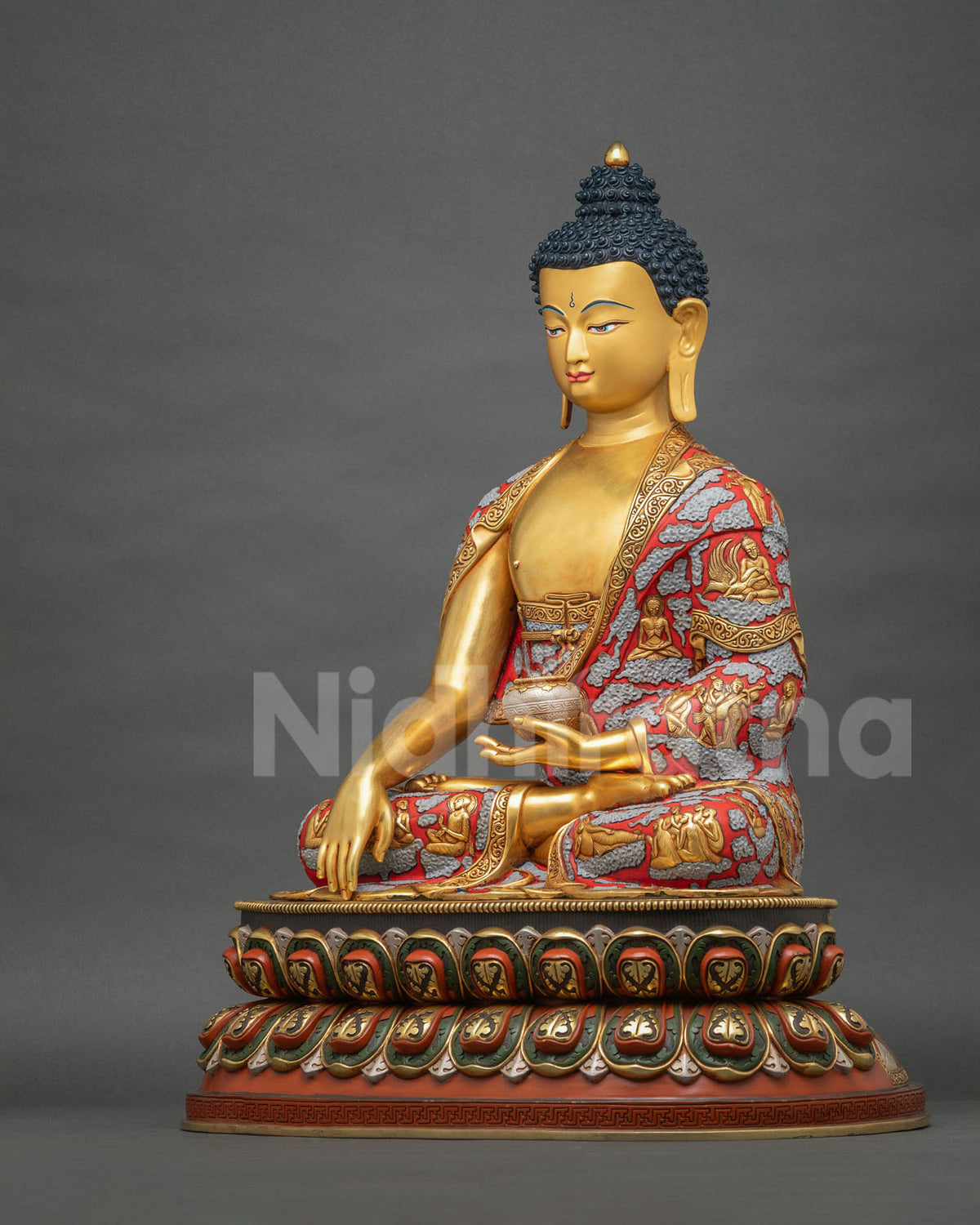 Profile of Shakyamuni Buddha statue in Bhumisparsha Mudra with sculpted life scenes on the robe