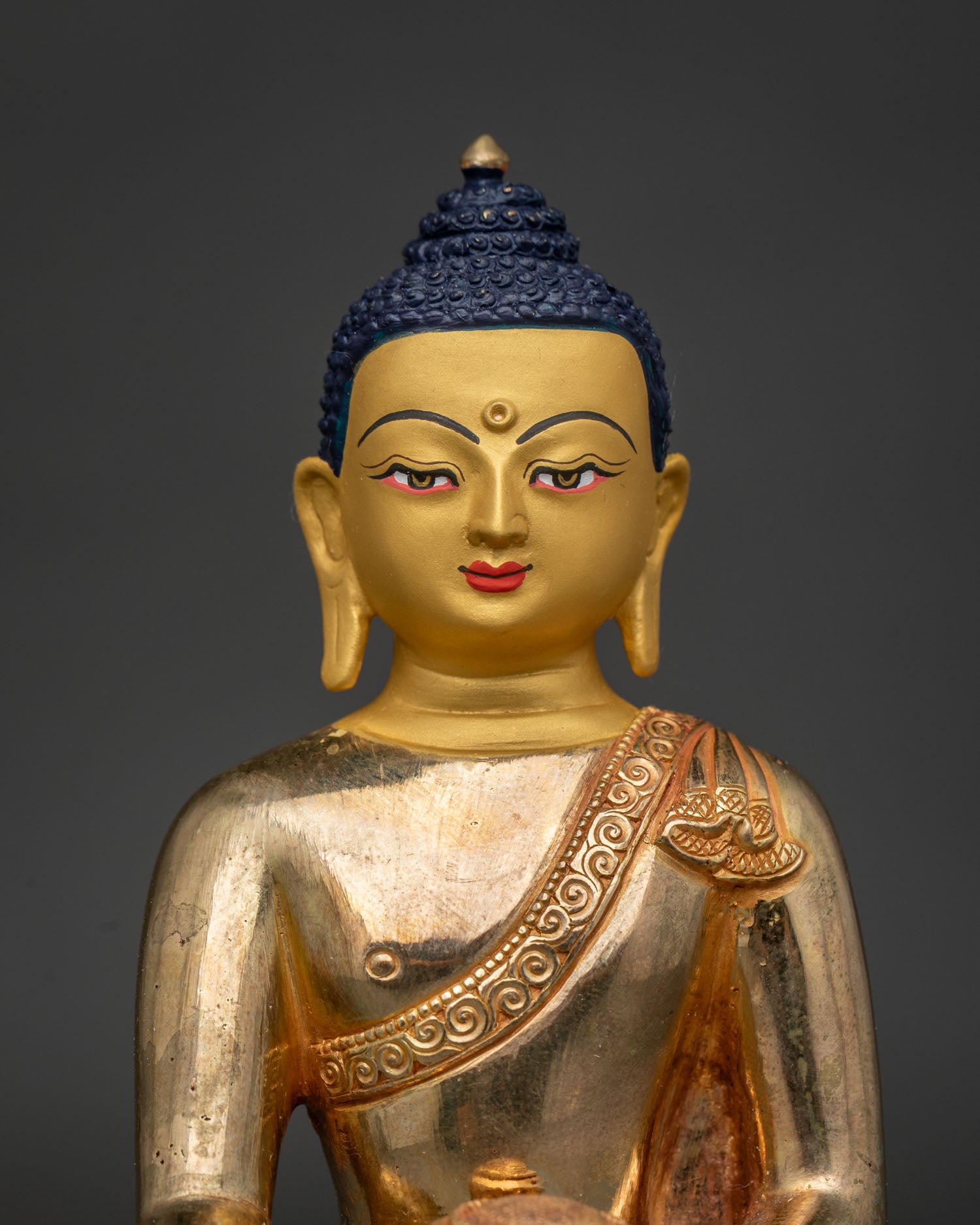 Ratnasambhava Buddha Statue Close Up 24K Gold Painted Face and Serene Expression.