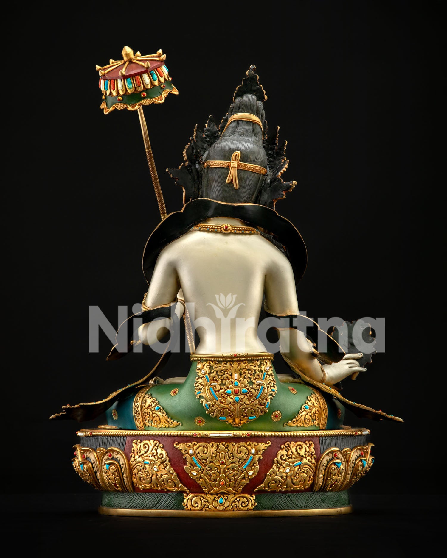 Rear angle of Dukar Buddhist statue showing gold-gilded back details and lotus base