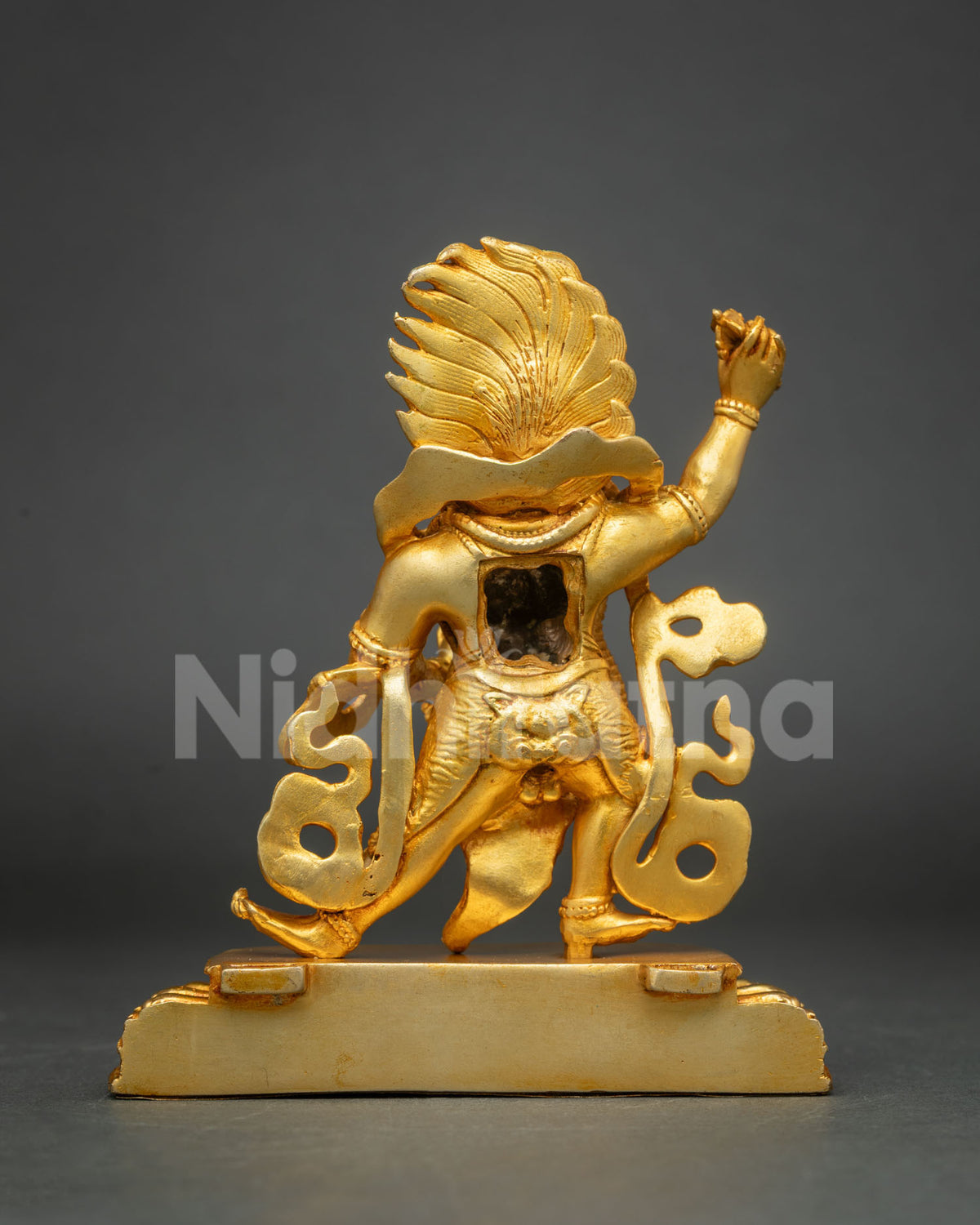 Rear angled view of fire-gilded copper Vajrapani statue showing back details and raised arm