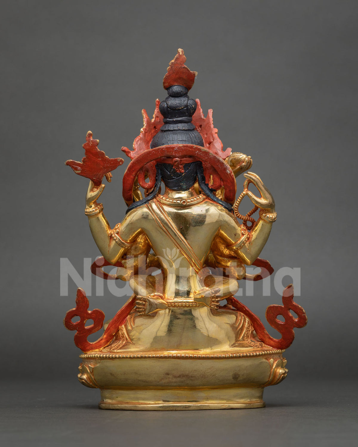 Rear view of Chenrezig Yab-Yum statue showing painted halo and gilded lotus base