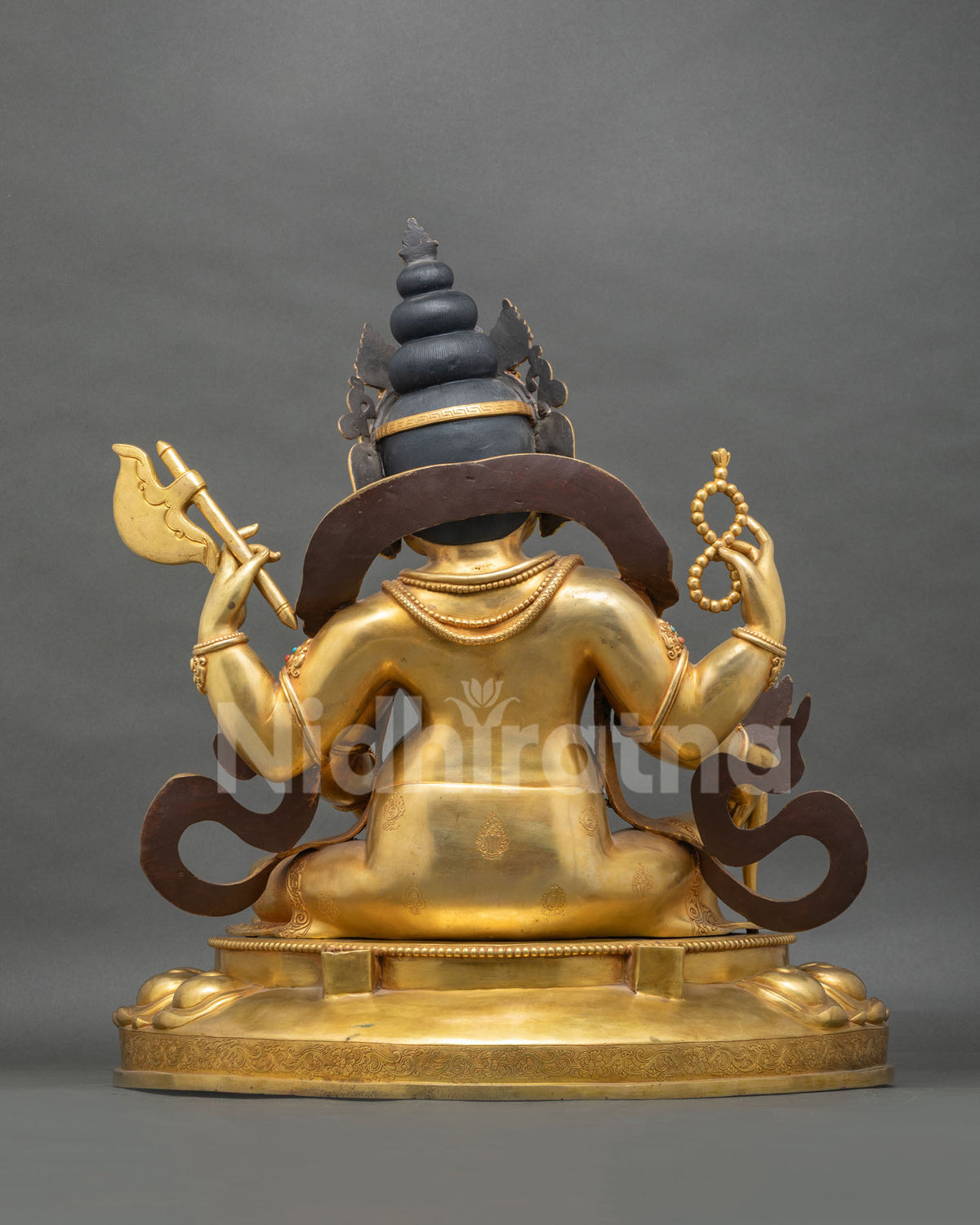 Rear view of Ganesh statue showing topknot, axe, rosary and detailed 24K gold fire-gilded back