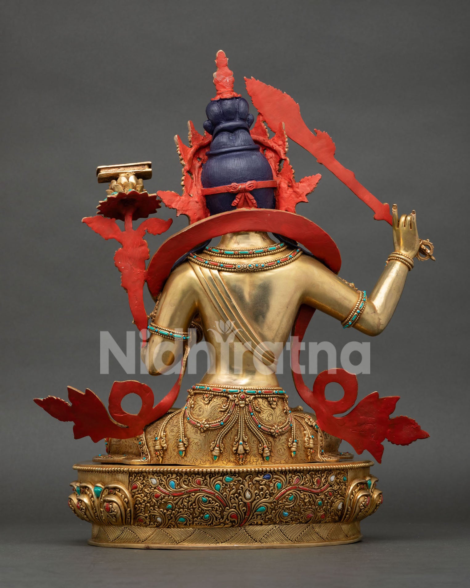 Rear view of Manjushri Statue revealing ornate craftsmanship and decorative lotus stems