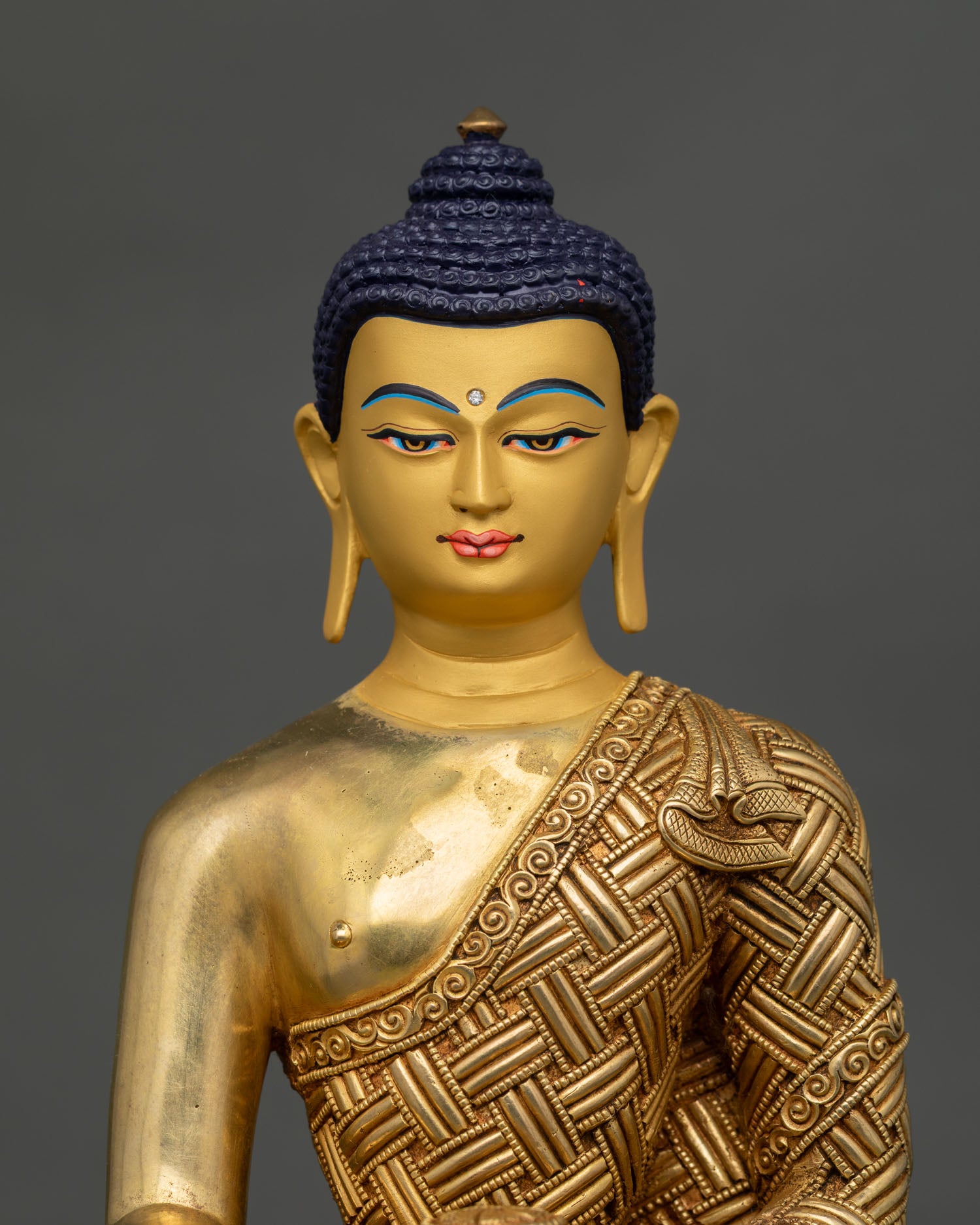 Handmade Shakyamuni Buddha statue with gold-gilded copper body and intricate repoussé robe details