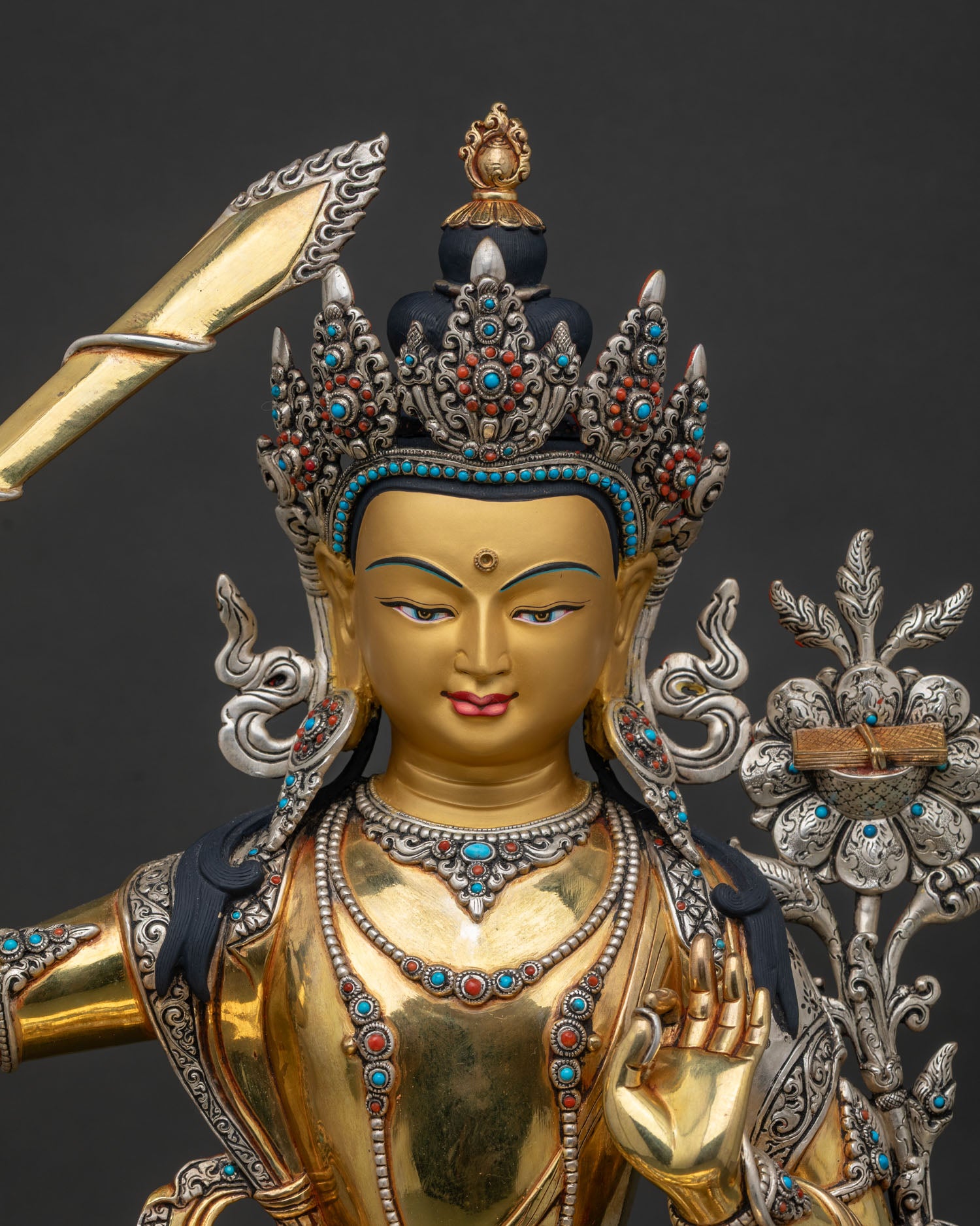 Close up of Manjushri Statue with gold gilding silver plating and intricate craftsmanship