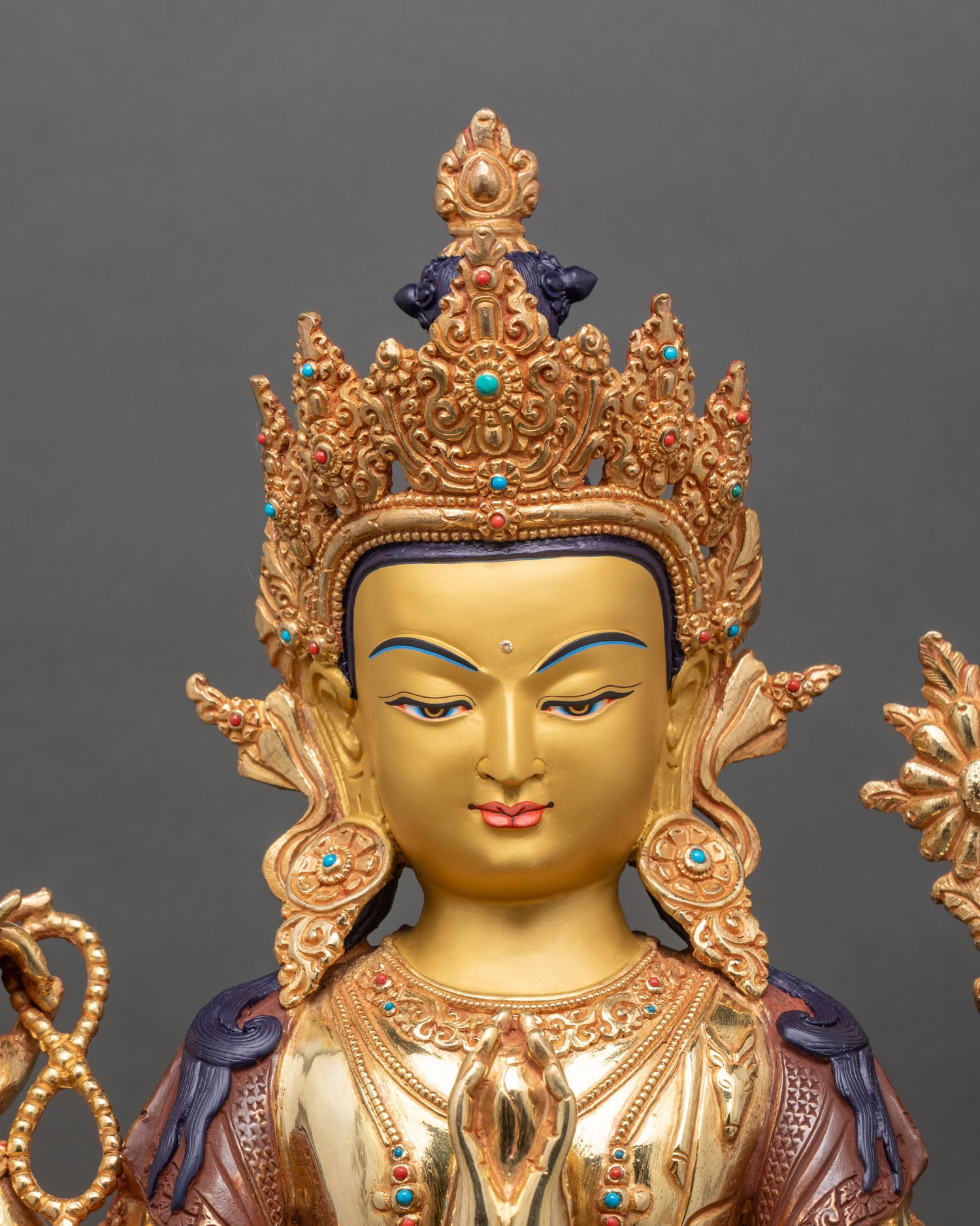 regular close up of chenrezig statue showing gold gilding and intricate handcrafted details