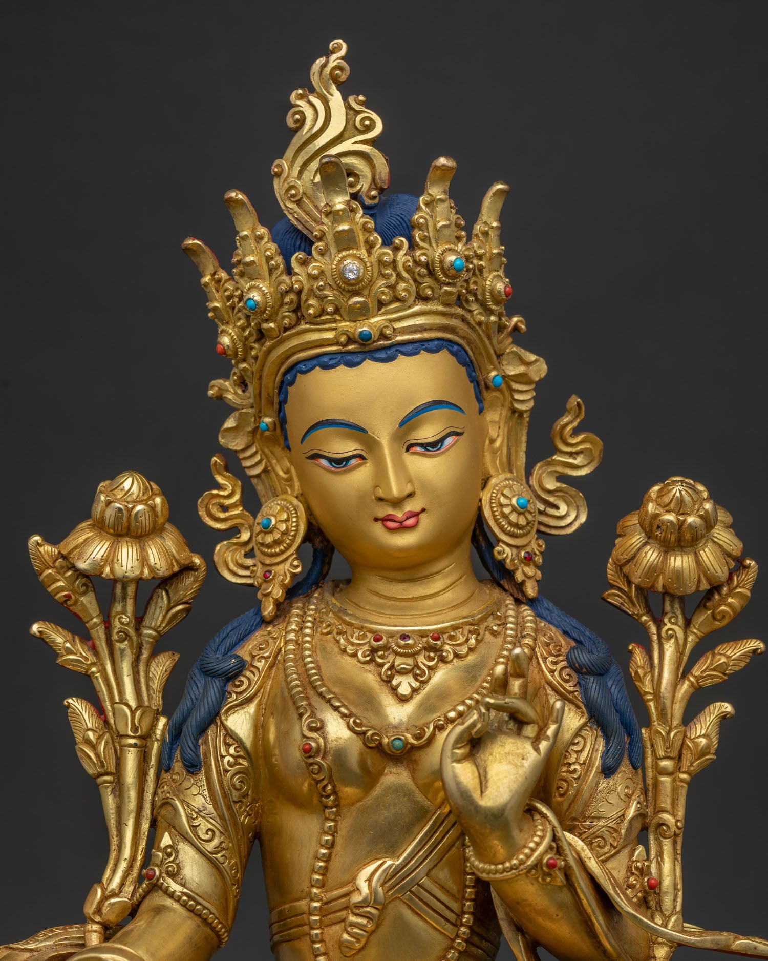 Regular close up of Green Tara Statue with gold gilding and gemstone details