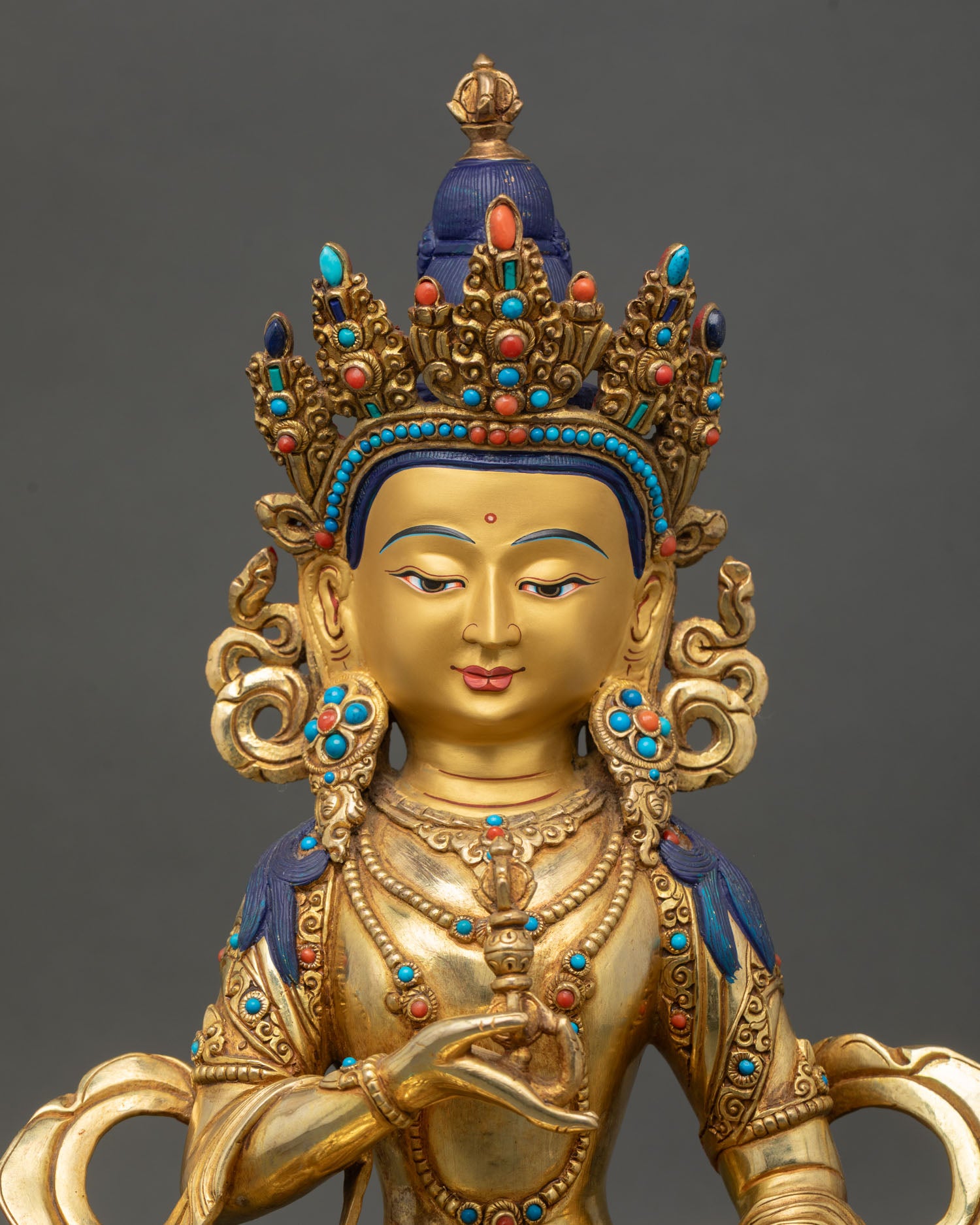 Regular close-up of Vajrasattva sculpture showing intricate ornaments and lotus seat details