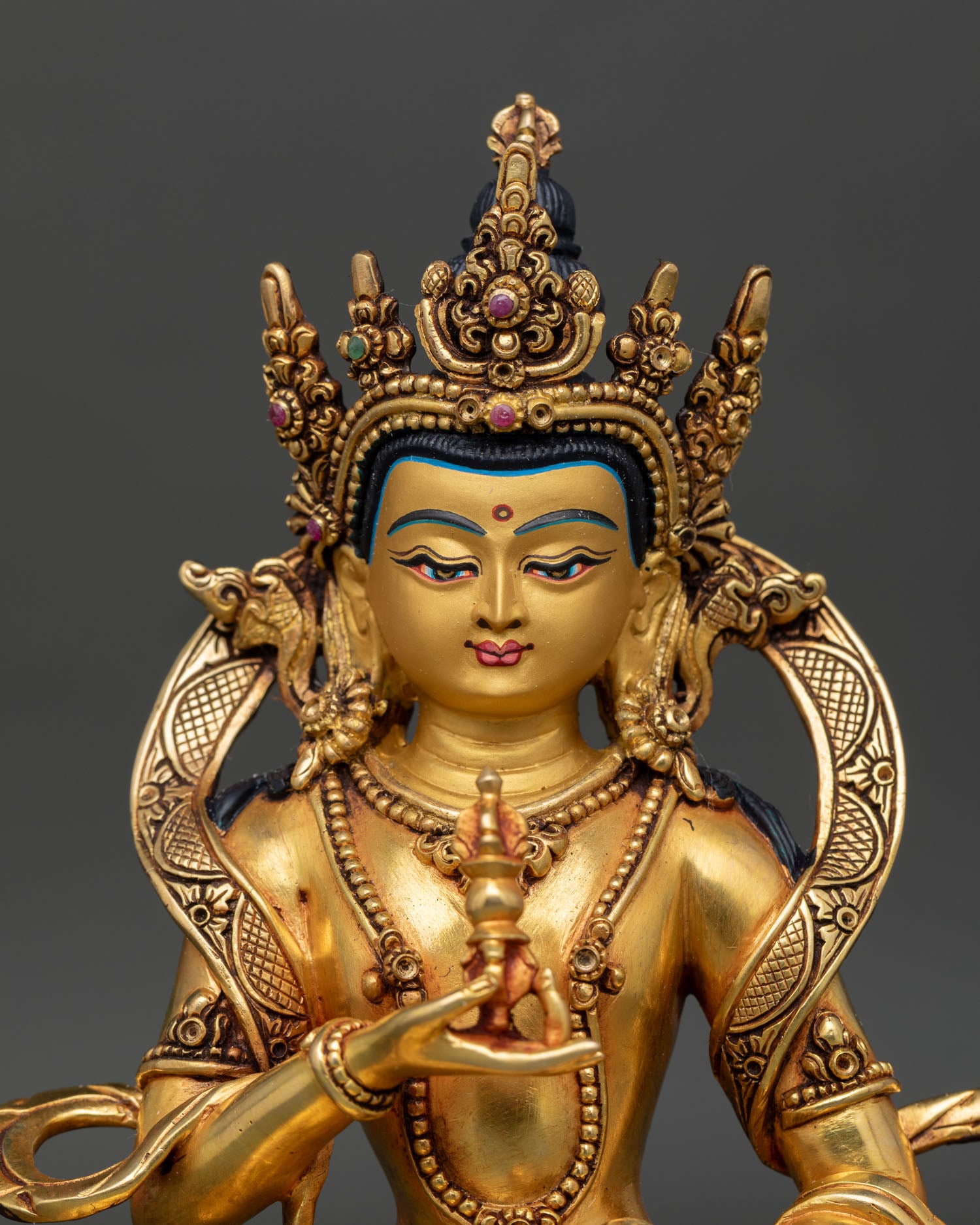 regular close up vajrasattva buddhist statue copper gold gilded detailing on robe and ornaments nepal