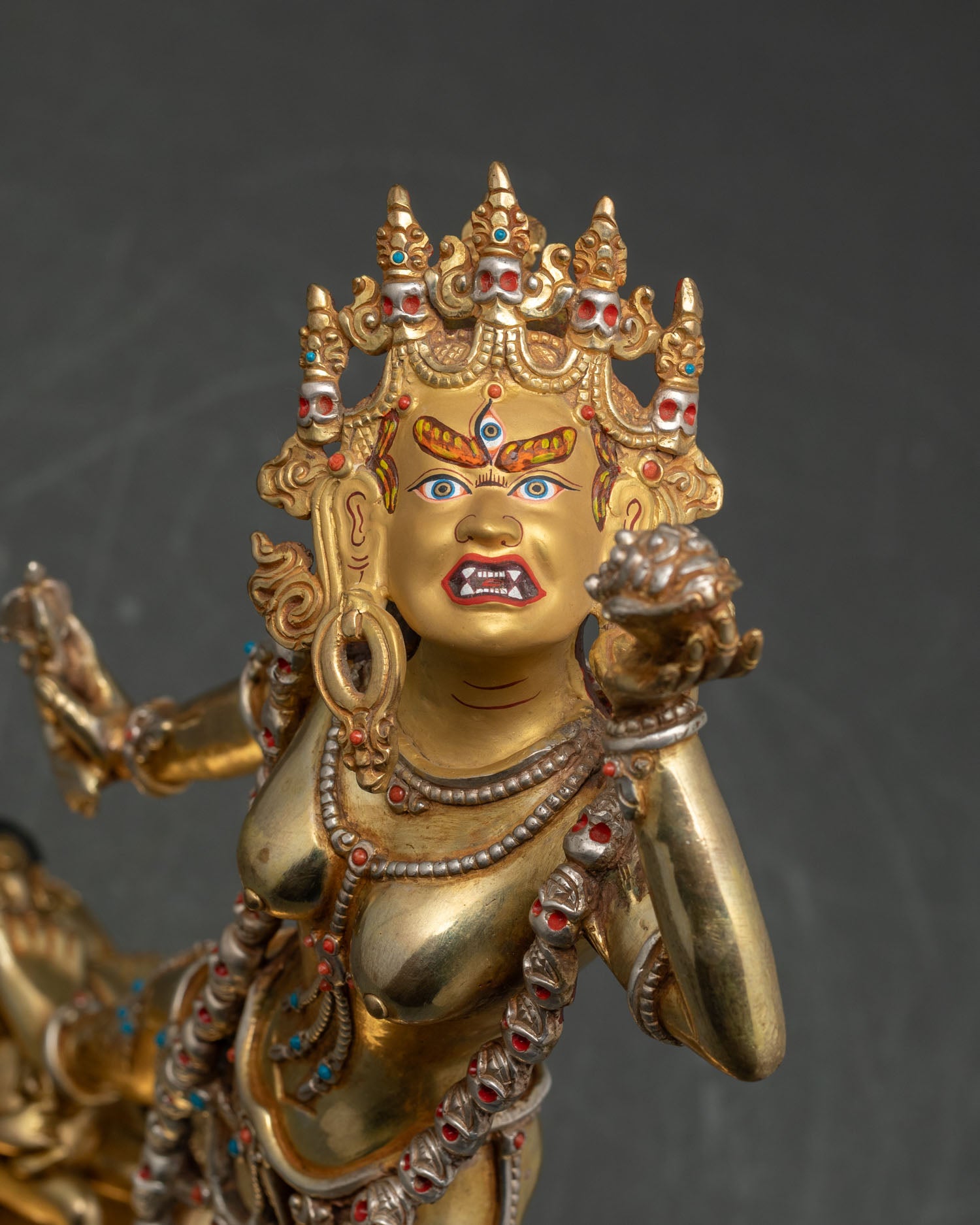 Regular close-up of Vajrayogini statue showing intricate gold gilding and gemstone details
