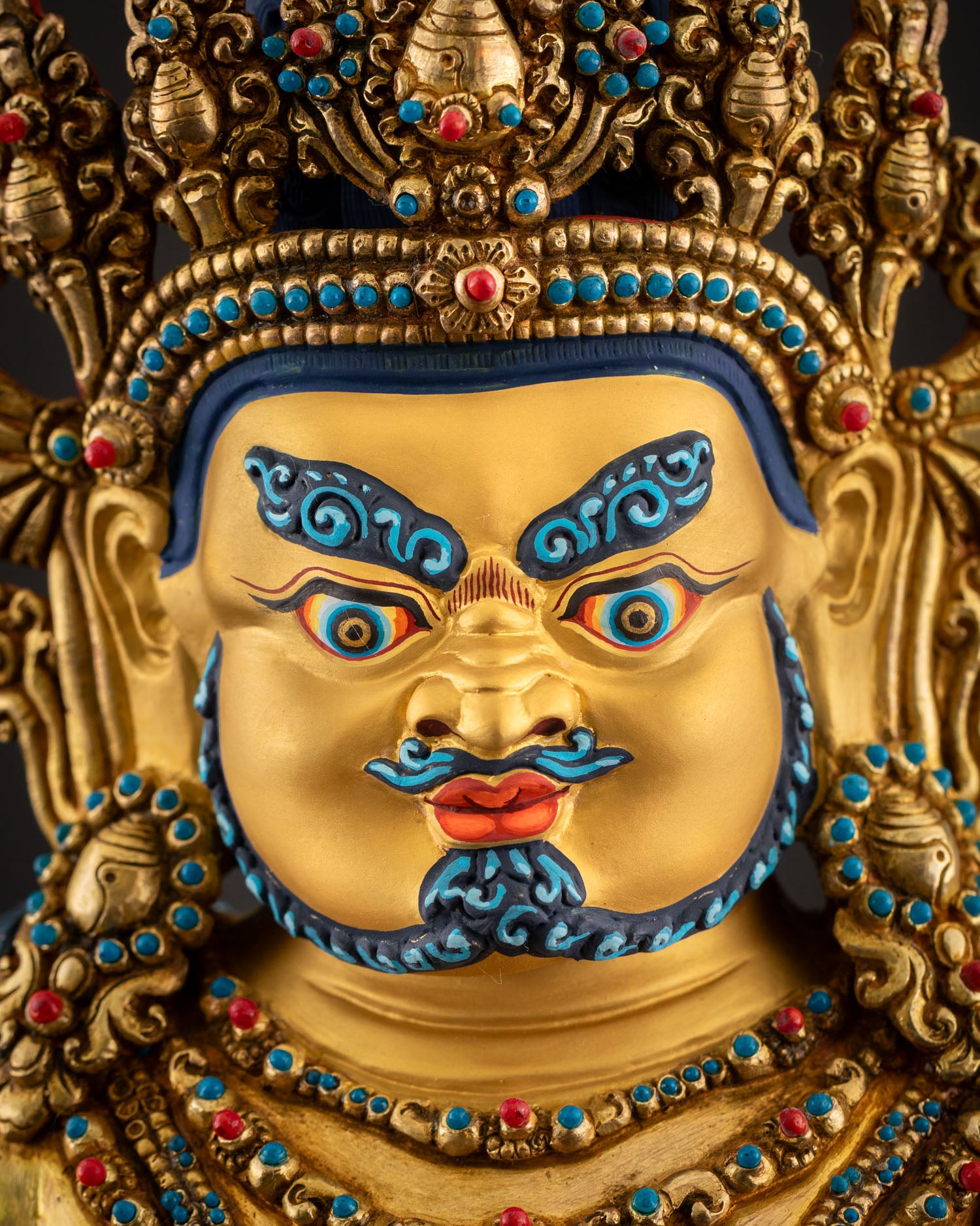 Regular close up view of Dzambhala statue jeweled crown turquoise coral inlay fine Himalayan details