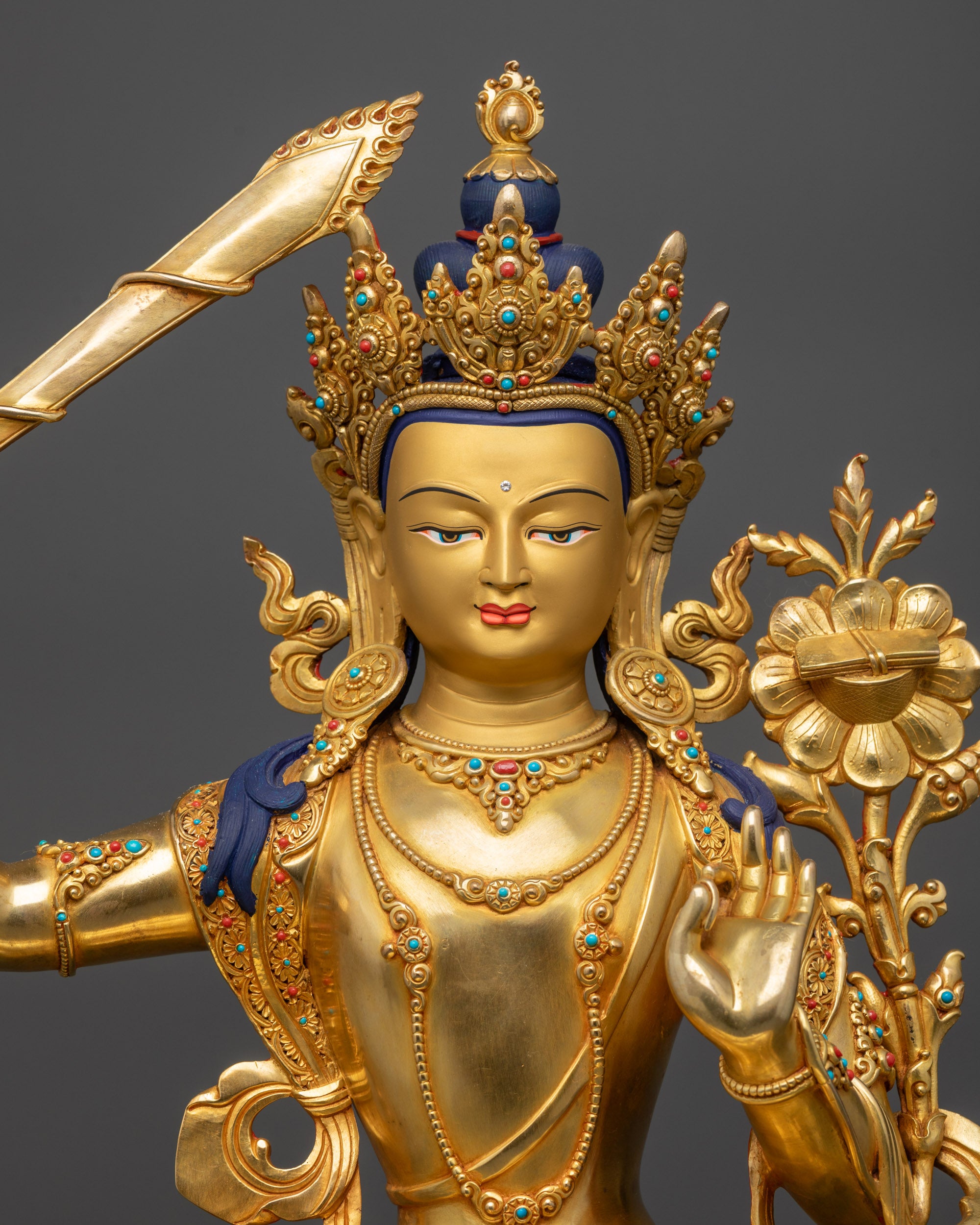 regular close up Manjushri statue showing carved swirling robe patterns
