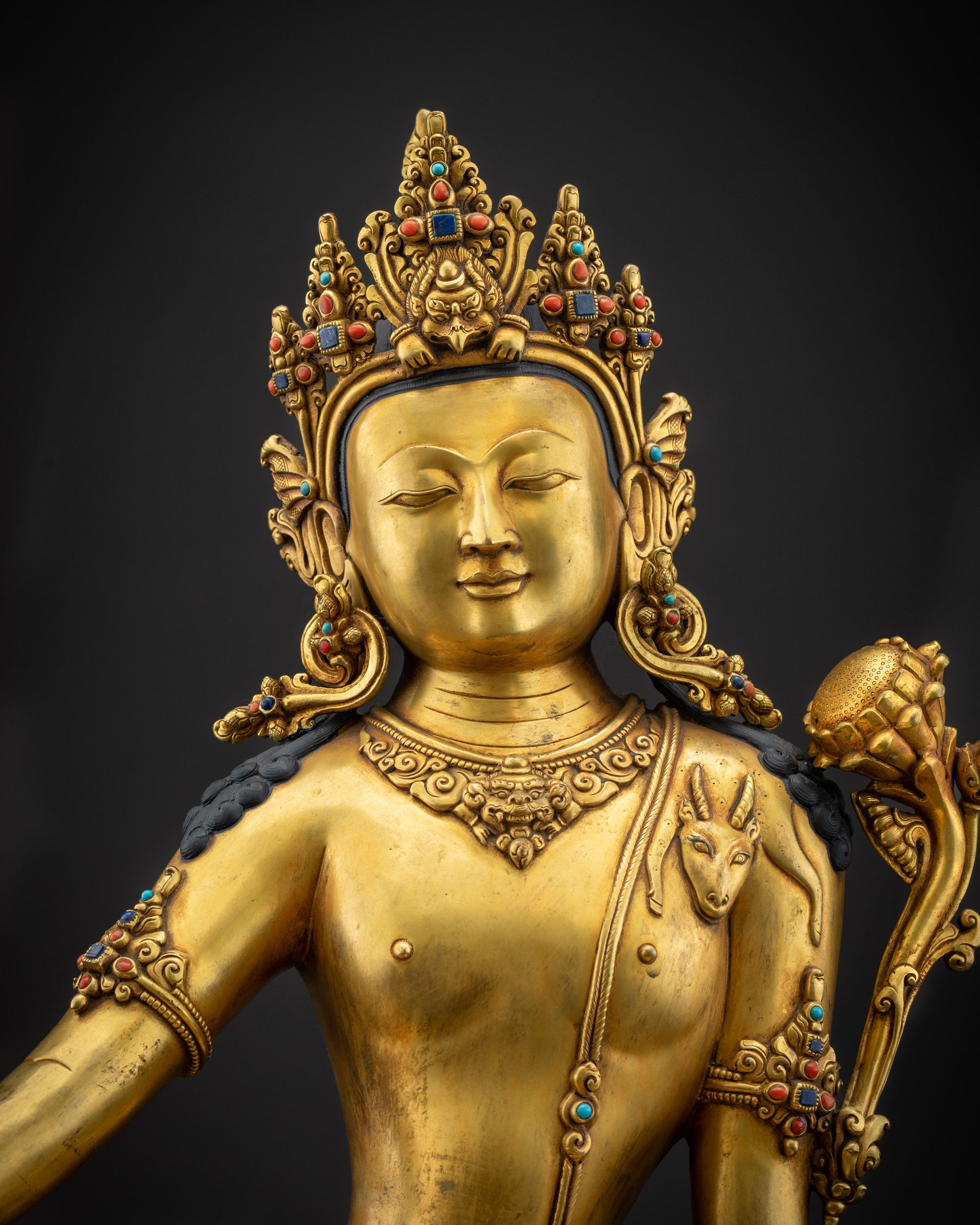 regular close up chenrezig statue showing carved jewelry and gold gilding