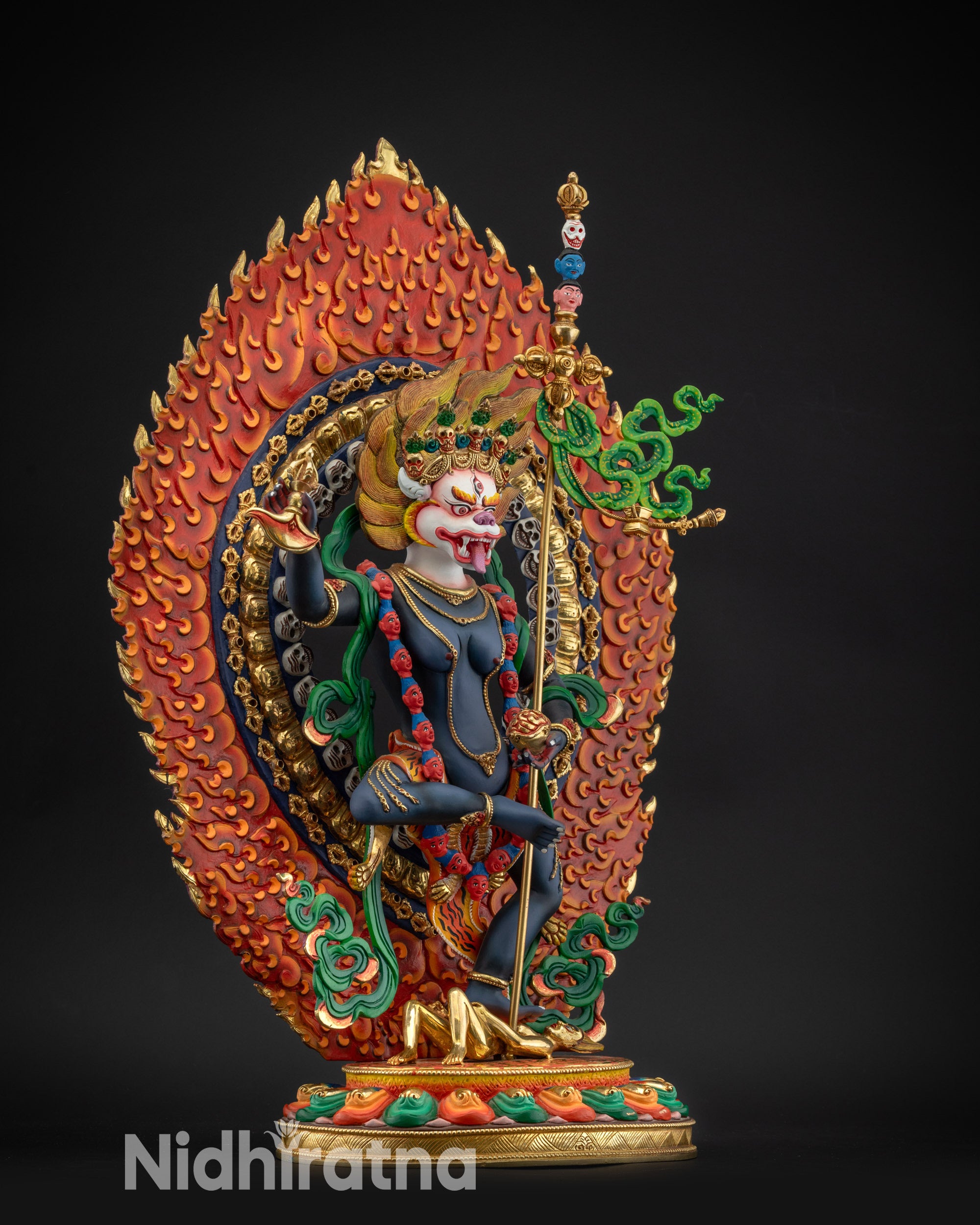 regular right side view Simha Mukha statue showing flowing garments and tiger-skin lower robe