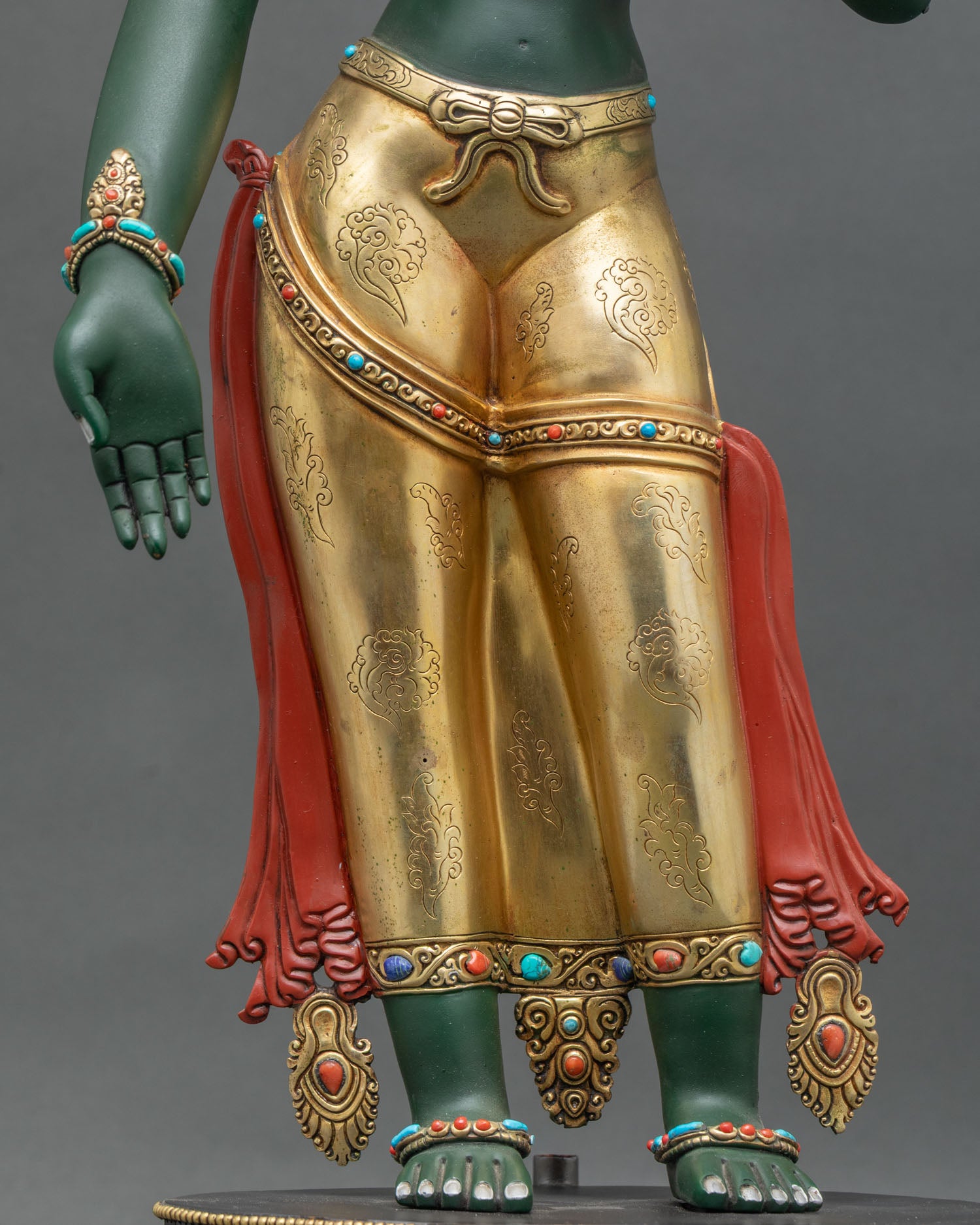 Repoussé-detailed Green Tara Statue with engraved gold garments, traditional Newari craftsmanship