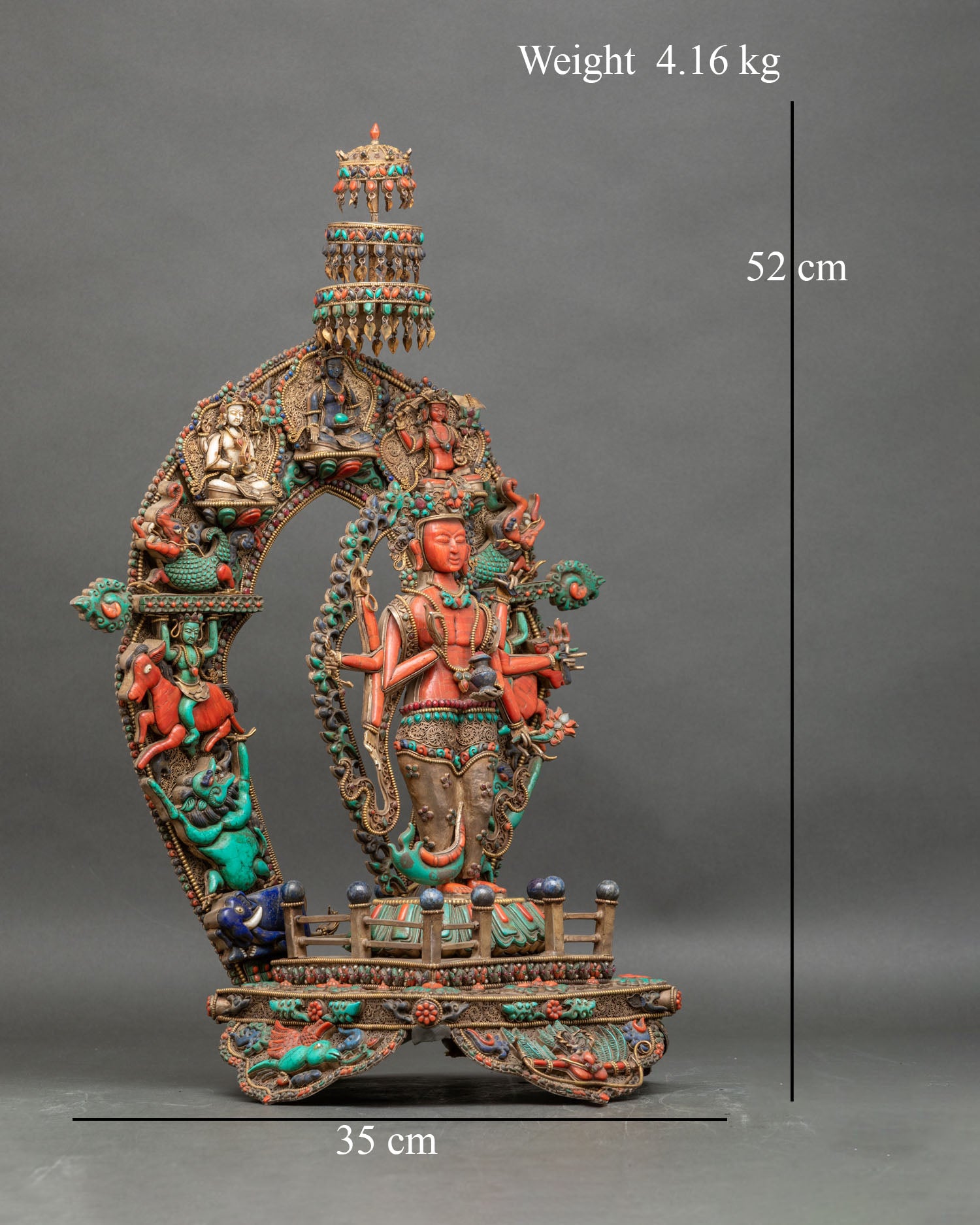Right profile of coral Avalokiteshvara statue with six arms, lotus throne, and jeweled aureole