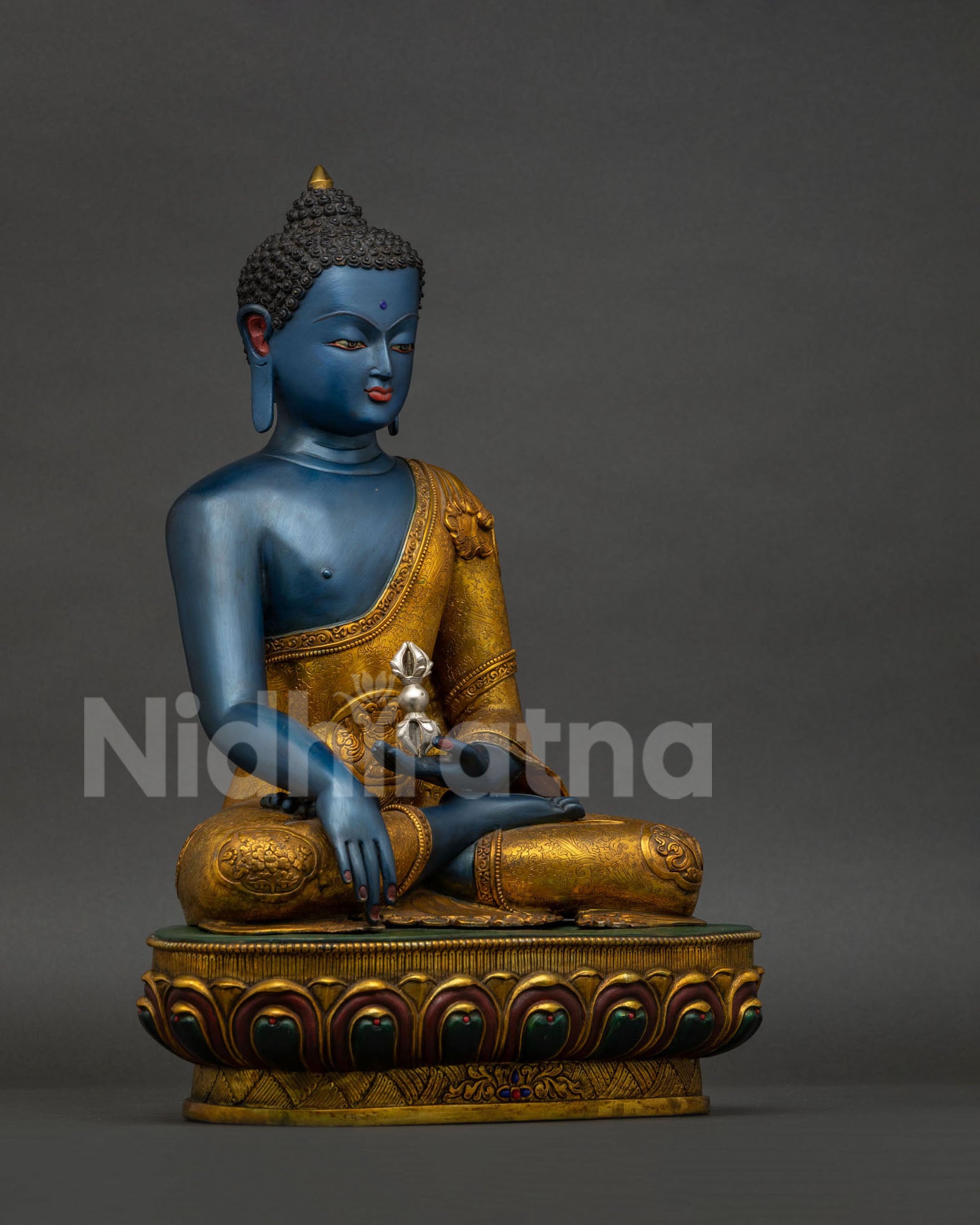 Right side view of Akshobhya Buddha statue showing gold gilded robe and lotus pedestal