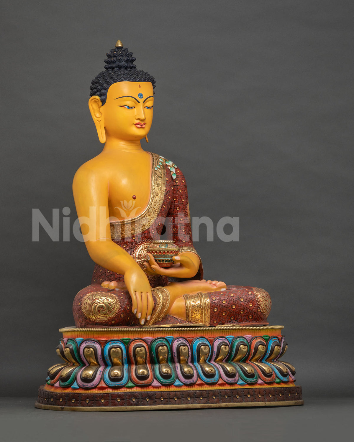 Right side view of colorful gold-gilded Buddha statue, Bhumisparsha Mudra pose