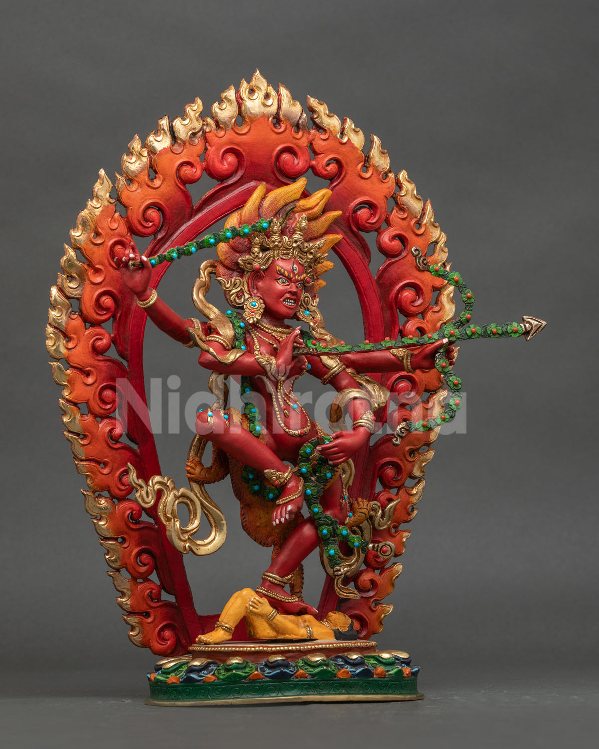 Right side view of Dancing Kurukulla copper statue with gold gilded details